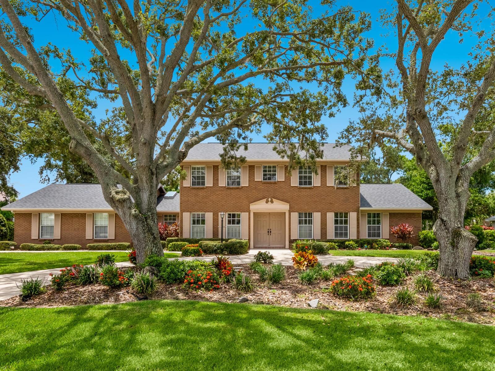 Nestled on a generous half-acre+ lot beneath majestic live oaks and
surrounded in lush Florida beauty, this timeless Southern Colonial residence offers
thoughtful classic architecture, exceptional privacy, and a true indoor/outdoor
lifestyle—all within the exclusive gated enclave of Beneva Oaks. Boasting 4 bedrooms, plus an office,
2.5 bathrooms, upstairs loft and 3,220 square feet of stylish comfort, this stately
home welcomes you through a roomy 2-story foyer with staircase and flows into
gracious formal living and dining rooms, a dedicated home office, and a welcoming
family room with vaulted ceilings, a wood-burning fireplace, and beautiful built-
ins perfect for relaxed evenings or entertaining in style. The heart of the home is a
chef-inspired kitchen, complete with high-end appliances, ample cabinetry, generous
prep space, and a large breakfast buffet. Rooms along the back of the home feature
vast sets of French doors opening wide to an incredible covered lanai, creating
seamless flow between indoor and outdoor living. Spend countless hours enjoying a
family style resort setting with saltwater pool and heated spa, a grilling station, and
tranquil views of a yard that backs to a small creek and protected green space
beyond a peaceful retreat with no rear neighbors for the utmost in privacy. The main-
level primary suite offers a quiet haven with generous space and a well appointed en-
suite bath, while three additional bedrooms and a loft with built-in shelving upstairs offer flexibility for
family, guests, or hobbies. Additional features include crown molding, skylights, newer
roof and A/C, brand new pool screen enclosure, an oversized two-car garage with a 2022 hurricane-impact door and circular
driveway. Located on the northern edge of Palmer Ranch, Beneva Oaks provides the
rare combination of peaceful seclusion and city convenience, with easy access to I-75,
Siesta Key Beach, Gulf Gate’s vibrant shopping and dining district, and a new Publix
just minutes away. Families will appreciate the home’s placement in top-rated school
zones, including Gulf Gate Elementary, Sarasota Middle, and Riverview High home to
the acclaimed International Baccalaureate Diploma (IBDP) and Career-related Program
(IBCP), the award-winning Kiltie Band, and a renowned Chamber Choir. Additionally,
Pine View School for the Gifted, consistently recognized at both the state and national
level as one of the country’s top public high schools, is just a 15-minute drive. With its
rare blend of elegance, privacy, outdoor living, centralized location, and top-tier
education access, this sprawling estate sized property is an exceptional gem in a highly
desirable community where your family’s storybook dream home will be cherished for
years to come!