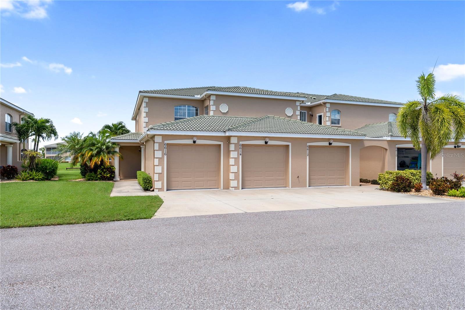 Enjoy breathtaking lake views from this spacious second-floor end unit in the gated community of Hidden Lake. Designed for both comfort and style, this 3-bedroom, 2-bathroom home features soaring 12-foot ceilings, high-impact windows and doors, and a light-filled open floor plan that enhances the sense of space and modern living. The kitchen is thoughtfully designed with white cabinetry, granite countertops, stainless steel appliances, and custom pull-out storage, making organization effortless. The living and dining areas flow seamlessly onto the screened-in lanai, where you can relax and enjoy serene views of the 5-acre lake. The primary suite is a private retreat, offering stunning lake views, direct lanai access, a walk-in closet, and a spa-like ensuite bathroom with dual granite vanities and a luxurious walk-in shower. The second bedroom includes a walk-in closet, while the third bedroom offers versatility as a guest room or home office. A dedicated indoor laundry area with wide French doors adds to the home’s convenience. Resort-style amenities at Hidden Lake include a swimming pool and spa, a clubhouse with a gourmet kitchen, dining room, fitness center, library/study, and scenic walking paths around the lake. Located just minutes from Anna Maria Island, Robinson Preserve, DeSoto National Memorial Park, shopping, dining, entertainment, hospitals, and SRQ Airport, this home offers both tranquility and easy access to everything you need.