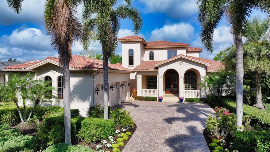 A refined masterpiece, this exceptional Marc Rutenberg home is perfectly positioned on a serene, nearly half-acre lakefront lot in Lakewood Ranch’s exclusive and distinguished community, The Lake Club. Blending elegance, craftsmanship, and tranquility, this residence is thoughtfully designed with classic architectural elements, including soaring ceilings, arched entryways, casement windows, enhanced crown molding, recessed lighting, and rich stone finishes and cabinetry. A long paver driveway and freshly painted exterior lead to a grand covered entry, where oil-rubbed bronze wrought iron double doors create a striking first impression. 4 spacious bedrooms, 4 full bathrooms, a dedicated office, and two versatile bonus/family rooms, one on each level, provide exceptional flexibility. The well-thought-out split floorplan ensures privacy, with each bedroom enjoying direct access to a full bathroom. At the heart of the home is a chef’s kitchen featuring Fieldstone cabinetry, granite countertops, premium GE Monogram appliances, central prep island with sink, counter-height bar seating, walk-in pantry, and panoramic views of the lanai and tranquil lake preserve beyond. The luxurious primary suite offers private lanai access and peaceful lake views, along with dual walk-in closets and a spa-style bathroom complete with dual vanities, soaking tub, large frameless glass walk-in shower, and private water closet. The second floor offers flexible living space with a spacious family room, bedroom, full bathroom, and a large covered balcony, perfect for multigenerational living, guest accommodations, or a private retreat. Outdoor living is elevated with two covered, screened lanais, one featuring a fully equipped outdoor kitchen, ideal for entertaining. A gas-heated saltwater pool and spa, surrounded by lush landscaping and serene views, provide a private sanctuary to relax or host guests year-round. Additional highlights include a 3-car side-entry garage, Leviton smart switches, built-in surround sound, zoned HVAC, fenced backyard, and generous storage throughout. Living in The Lake Club is more than homeownership, it’s a lifestyle. This prestigious, guard-gated community offers a 20,000 SF clubhouse with dining and bar service, 2 resort-style pools, state-of-the-art fitness and wellness center, tennis and pickleball courts, basketball, concierge services, and a full calendar of social events. Residents enjoy proximity to top-rated schools, fine dining, Waterside Place, UTC Mall, downtown Sarasota, and the world-renowned beaches of Siesta Key and Lido. This custom estate captures the very essence of timeless Florida living.