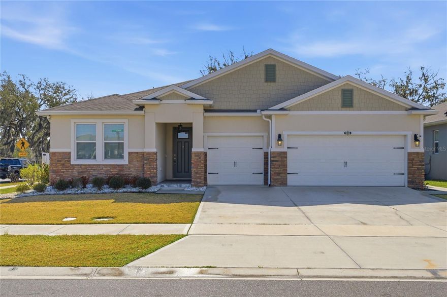 Welcome home this stunning, nearly-new showcase home built in 2023! Offering a sprawling **2,851 sq. ft. of living space**, this home is perfectly positioned on a premium **corner lot with NO rear neighbors**, giving you the ultimate sense of privacy and peace.
Step inside and be wowed by the bright, open-concept floor plan designed for modern living. You'll find gorgeous, easy-to-maintain ceramic tile flowing seamlessly throughout the home. The soaring **high ceilings**, elegant tray details, and a chic custom geometric accent wall give the main living area a true model-home feel. The heart of the home is the spectacular chef’s kitchen, featuring crisp white shaker cabinetry, beautiful granite countertops, stainless steel appliances, modern pendant lighting, and a massive center island that overlooks the expansive living and dining spaces. Ready to take the fun outside? Step through the sliding glass doors to your **covered patio**, the perfect spot for your morning coffee or weekend BBQs! 
**THE SHOWSTOPPER: A FULL IN-LAW SUITE!**
Whether you have extended family, frequent visitors, or want an amazing private guest retreat, this home delivers! The attached in-law suite boasts its own **private entrance, a cozy living room, a fully-equipped kitchen, and a spacious master bedroom**. It’s the perfect NextGen setup! 3-Car Garage Plenty of room for vehicles, a golf cart, or extra storage! Corner lot property, beautiful stone accents, and serene nature views out back. Why just buy a home when you can gain a lifestyle? The highly sought-after Kindred community is an absolute dream, loaded with **THREE incredible amenity centers**. Spend your weekends lounging by the sparkling resort-style pools, watching the kids play at the expansive shaded playgrounds, or staying active on the miles of beautifully paved **walking trails** winding through lush Florida conservation. This rare 2023 build gives you all the perks of new construction without the wait. Don’t miss your chance to own this multi-generational masterpiece in one of Kissimmee's best communities! Schedule your Private Tour Today!!