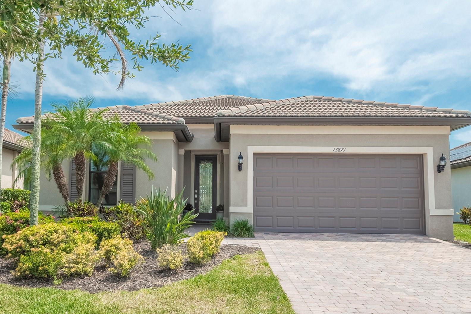 Welcome to your own slice of paradise in Venice’s most sought-after resort-style community, Islandwalk at Wellen Park. This elegantly upgraded Summerwood model boasts 3 spacious bedrooms, a versatile den/office, and an open-concept layout designed for effortless entertaining and relaxed luxury living. Step into the light-filled kitchen where new quartz countertops with a waterfall backsplash, and shaker-style cabinetry create a crisp and elegant space. Stainless steel appliances, a large island, and designer lighting make this the true heart of the home. The adjoining living and dining areas feature 8’ doors, upgraded tile flooring, recessed lighting, and plantation shutters throughout, blending comfort with sophistication. What truly sets this home apart is its unique privacy (which you'll have to see for yourself) and show-stopping outdoor oasis. Located on a serene lakefront lot, you’ll enjoy breathtaking sunset views from the expansive travertine lanai, which includes an oversized covered patio, heated saltwater pool with sunshelf and water features, and a luxurious spa. Storm Smart hurricane shutters on the lanai and accordion shutters on all windows allow for peace of mind year-round. The private owner’s suite is a tranquil retreat with tray ceilings, a window overlooking the water, and an en-suite bathroom with frameless glass shower, dual vanities, and a custom walk-in closet. The split-bedroom floor plan ensures ultimate comfort for guests and family members alike. Islandwalk is a vibrant yet serene, golf cart-friendly community offering two resort-style amenity centers, three pools, tennis and pickleball courts, a state-of-the-art fitness center, dog park, and miles of scenic walking trails. The HOA provides true maintenance-free living with professional landscaping, high-speed internet, and 24-hour staffed gate security. Ideally located just minutes from Wellen Park, CoolToday Park, Tamiami Trail, and I-75, this home provides seamless access to shopping, dining, live entertainment, Gulf beaches, and historic Downtown Venice. A private resident-only back gate offers a traffic-free shortcut to the excitement of the Town Center and stadium. If you’re searching for luxury, privacy, and lifestyle, this rare Islandwalk gem checks EVERY box.
