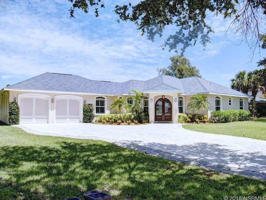 Beautiful luxury home located in desirable New Smyrna Beach neighborhood between Riverside Drive and the Intracoastal Waterway. This home has high ceilings, Brazilian cherry flooring, crown molding, and many upgrades thoughout. From the pavered driveway, the entrance is a covered travertine walk-up with large mahogany double front doors. A spacious great room with a gas fireplace, Hunter Douglas shades, and french doors opens to beautiful covered patio area.The  pool/spa with water features, a gas grill hook up and an outdoor shower. The granite/stainless kitchen has a gas stove, cherry cabinetry, and top of the line appliances. The granite/travertine baths, mirrored closet slider doors and MB walk in closet, wall vacuum, large insulated garage, double pane impact windows, and great landscaping are just some of the many high end features of this home. It's a must see to fully appreciate the many upgrades and luxurious lifestyle this house offers! Click on the link to see the 3D walk-through right now! ;Water: City