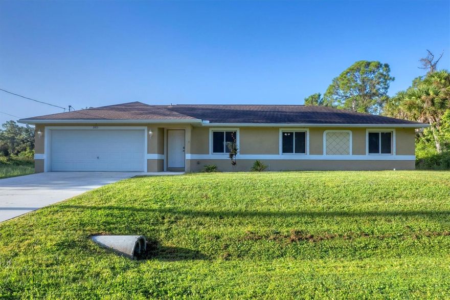Move-in ready 2016 home in desirable North Port Estates situated on an oversized lot in an X flood zone and filled with upgrades! This beautifully maintained 3-bedroom, 2-bath, 2-car garage home offers privacy, modern comfort, and Florida living at its best. Enjoy vaulted ceilings, tile flooring throughout, and an open-concept floor plan ideal for entertaining or relaxing. The kitchen features granite countertops, matching backsplash, hardwood cabinetry and a breakfast bar with pendant lighting. The primary suite includes ample closet space with an ensuite bathroom that has a granite-topped vanity and a linen closet. With two guest bedrooms and a second full bath for family or friends. Step outside to a screened-in lanai and beautiful backyard surrounded by nature and frequent wildlife sightings. Additional features include hurricane shutters, a new AC coil (May 2024), monthly serviced well filtration system, updated light fixtures, Ring doorbell, garage door opener, fiber optic WiFi hookup and all appliances. Located just minutes to I-75, US-41, shopping, dining, nature parks, and sandy beaches—schedule your private showing today!