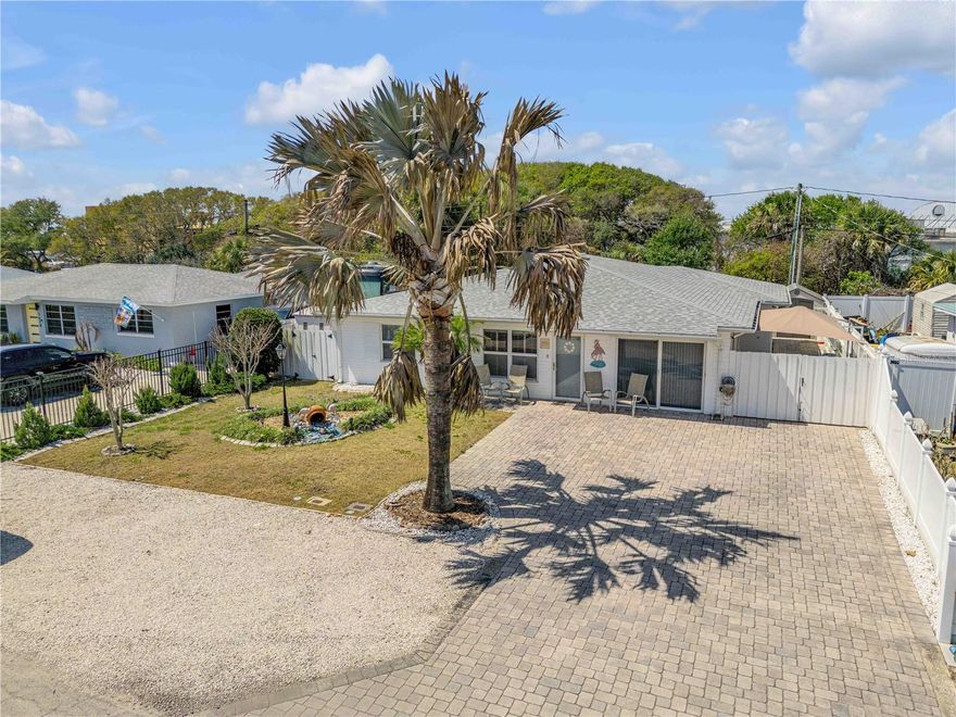 This 4Bd, 3Ba home with 2025 sq ft of living space is located within a couple of blocks to the beach and major shopping centers.  The living room opens to both kitchen and the dining area and is flooded with natural light. The kitchen appliances have been updated and most are stainless steel. The home has ceramic tile and ceiling fans throughout. The roof was replaced yr 2021, while the HVAC system was replaced in yr 2020. There is a Rain Soft water softener system and a 7 zone irrigation system.  The primary suite has pocket doors on the closet and bathroom allowing access for wheel chairs.  The 4th bedroom could be used as an in-law suite which comes complete with a private bathroom and Murphy Bed. No residence is located behind the property, offering added privacy. The back patio features a retractable awning. Outside the fenced-in back yard has sheds with one attached to the home with electric service.  The front driveway and back patio has pavers. Additional storage is available in the attic, accessible through the pull-down stairs. Electrical service is underground and the home has gutters all around. Hurricane windows. This home is perfect as a primary residence, vacation get-away or an investment property.