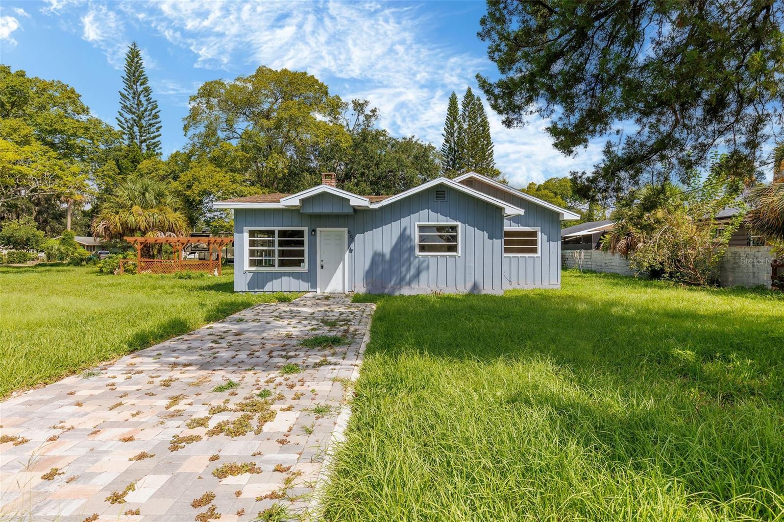 This charming 3-bedroom, 2-bath home sits on a generous half-acre lot and is offered at an unbeatable price of just $209,900. Bursting with character, it features a cozy brick fireplace, durable vinyl plank floors, a bright white shaker kitchen, and updated bathrooms. While it could use a little TLC, the potential here is endless. Enjoy the screened porch, pergola, and storage shed, all adding to the home's value and versatility. Whether you're a first-time buyer looking for affordability or an investor searching for a great rental property, this home checks the boxes. Conveniently located just ten minutes from the beach, I-95, and local colleges and universities, it offers the perfect blend of comfort, potential, and location. Cash or conventional financing. WH 2011, HVAC 2024. All information taken from the tax record, and while deemed reliable, cannot be guaranteed.
