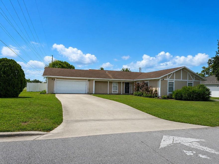 One or more photo(s) has been virtually staged. Located in the heart of Deltona, this spacious 4-bedroom, 2-bath ranch-style home offers 1,872 square feet of comfortable living space on an oversized 0.32-acre corner lot. Featuring an open floor plan with a formal living room, eating space in the kitchen, and solid stone countertops, this home is designed for both everyday living and entertaining. The kitchen includes a closet pantry, while interior highlights feature tile and carpet flooring along with a cozy wood-burning fireplace. The attached 2-car garage provides ample parking and storage. Outside, enjoy mature landscaping, shade trees, and a paved street location close to shopping, schools, and public transportation. Additional features include central heating and cooling, city water, septic system, and high-speed internet availability. Conveniently located near Howland Blvd with easy access to major roadways, this move-in ready home is a must-see — schedule your private showing today!