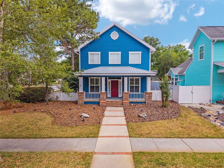 Positioned on a corner lot, this thoughtfully updated Town of Tioga home presents a striking first impression, where a charming blue exterior is framed by crisp white trim, and a classic white picket fence. A vibrant red door introduces a sense of character, while a covered front porch overlooks peaceful green parkland, creating a setting that feels both welcoming and quietly connected. Inside, the home opens with a sense of space and light. Vaulted ceilings rise above the main living area, where dark plank flooring grounds the space and clerestory windows draw in natural light from above. Set beneath a dramatic chandelier, a wall of built in shelving balances form and function while the corner fireplace anchors adds a sense of elegant comfort. The layout unfolds with intention, guiding the flow to a dedicated dining space defined by an oversized picture window and its own refined lighting. A built-in sideboard adds both utility and elegance, creating an ideal setting for entertaining. Beyond, the kitchen is composed with clarity and purpose. Full height cabinetry offers abundant storage, while a chef’s range with a Viking hood vent and carefully selected finishes create a space that is both functional and elevated. Upstairs, the primary suite offers a retreat shaped by vaulted ceilings and rich flooring underfoot. A private balcony extends the space, overlooking the yard and inviting quiet moments. The suite is complemented by a generous walk-in closet with built-in organization and a 5-piece bath featuring a deep soaking tub. Two additional upstairs bedrooms are equally well considered, each filled with natural light and offering flexibility for a range of uses. A well appointed ground level laundry room adds ease to daily routines with thoughtful storage. Outdoor living continues in the backyard, where a level private setting is framed by fencing and softened by intentional design. A brick patio sits beneath a pergola extension from the upper balcony, creating a layered outdoor environment suited for both gathering and quiet enjoyment. A rear-entry two car garage completes the home’s functionality, offering convenience while preserving the integrity of the front elevation. Located just moments from Tioga Town Center restaurants, fitness center and MORE, this home pairs timeless design with a highly connected setting, offering both comfort and access within one cohesive and compelling experience.
