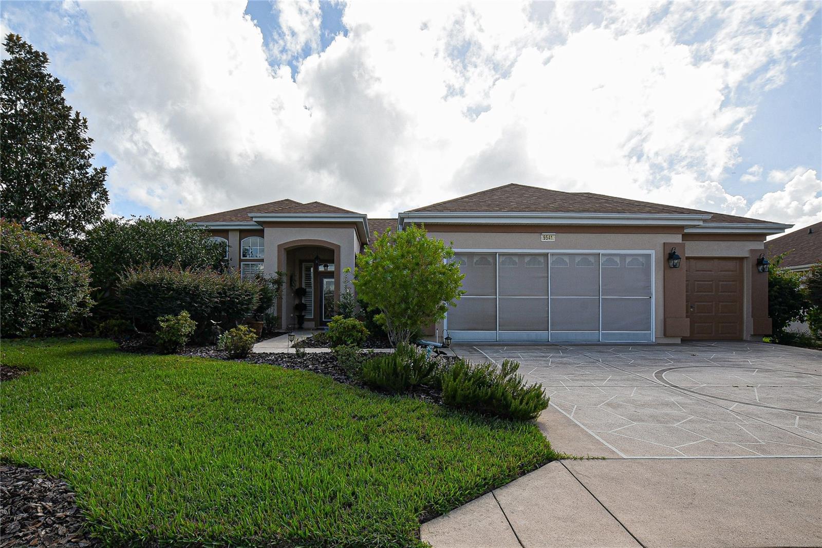 Discover your dream home in this exquisite 1936 sq. ft. Sanibel model sanctuary, where every detail has been thoughtfully curated to enhance your daily life. As you step into the inviting living room, you're greeted by warm, rich hardwood floors and a flood of natural light from large windows, creating an atmosphere of openness and tranquility. Plus, a beautiful glass entry door leading to an inviting foyer.
The heart of this home is the beautifully appointed kitchen, featuring sleek stainless-steel appliances, elegant granite countertops, and crisp bisque cabinetry. This culinary haven is perfect for both everyday meals and entertaining guests, with ample space to unleash your inner chef. High ceilings and beautiful arched windows enhance the dining area.
Retreat to the luxurious primary bedroom, a spacious 270 sq. ft. oasis designed for ultimate relaxation. The en-suite bathroom boasts a indulgent soaking tub and a separate shower, providing a spa-like experience in the comfort of your own home.
For those who work from home, can the 3rd bedroom can be used as a den. The second bedroom is extended in size and provides versatility, easily transforming into a guest room or hobby space to suit your lifestyle needs.
Throughout the home, stylish ceiling fans and carefully chosen light fixtures add both functionality and flair. Features include crown molding, Plantation shutters and more. The harmonious blend of warm and cool tones in the decor creates a welcoming ambiance that will make you feel instantly at home.
Outside, lush greenery beckons through the windows, promising serene views and a connection to nature. This property isn't just a house; it's a canvas for your dreams, a place where memories are made, and a testament to your success. The enlarged lanai is great for relaxing and back yard is deep and semi-private.
The garage is extended and has a golf cart garage that is enclosed and can be utilized as a large workshop or extra storage. Roof was re-shingled in 2021. HVAC new in 11/2017. Roomy inside laundry with extra cabinets.
Embrace the lifestyle you've always desired in this thoughtfully designed, move-in ready home that perfectly balances comfort, style, and functionality.