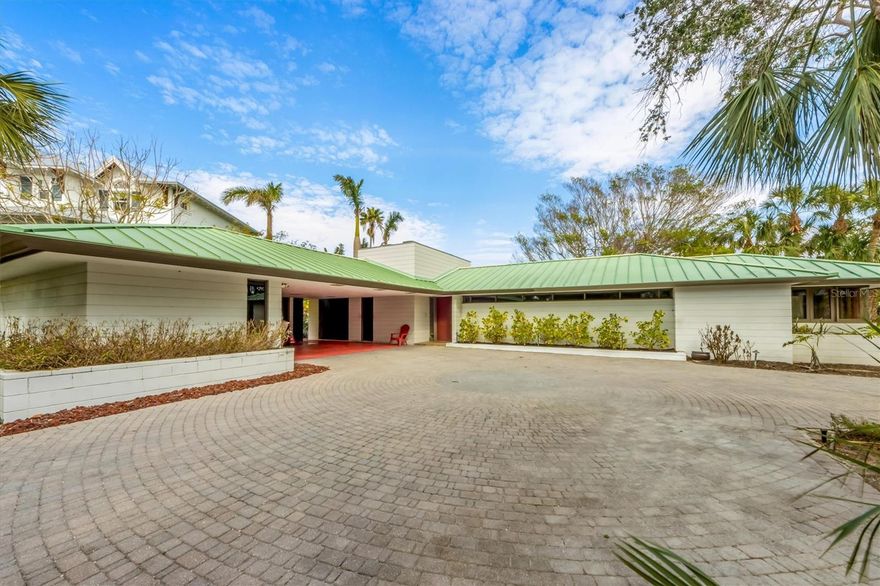 Discover this Architectural Gem designed by H. Patterson Fletcher, a protégé of the legendary Frank Lloyd Wright. Perfectly situated on a spacious trapezoidal corner lot where two deep canals meet and 2 blocks away from the gorgeous Gulf of Mexico beaches. Don't miss out on this one of a kind prime lot on prestigious Willow Avenue in Anna Maria!  This 4 bedroom, 3 and a half bathroom home is spacious and comfortable for any large family and guests.  The studio is detached and located across the carport and includes a large room and a full bathroom. As you walk in, you are greeted by gorgeous tidewater cypress wood walls and vaulted ceilings, light and bright natural light throughout.  The open concept dining and living area is very warming and includes the exposed concrete block fireplace, the home’s massive centerpiece, anchoring it to the earth in the tradition’s of Wright’s architecture.  The windows are perfectly placed to maximize the canal and pool views and minimize views of neighboring houses.  The long hallway has built-in cabinets throughout for plenty of storage space.  In the 2 hallway guest bedrooms they both have convenient unique built-in desks and closets.  The primary bedroom has a cedar wood walk-in closet and en-suite bathroom with dual sinks.  The French doors lead you out to the screened in lanai ideal to have your morning coffee.  The backyard oasis with lush landscaping provides privacy while allowing views of the canal leading straight out to Bimini Bay.  Relax in the large pool, enjoy the cool vibes of the fig tree, the turf as well as an oversized wood deck for outdoor dining and grilling.  Step onto the dock and enjoy Florida’s wildlife and nature views.  Manatees and dolphin frolicking in the canals, use the dock ladder and hop right on kayaks or paddle boards for a stroll.  Walking distance to the heart of Anna Maria's Pine Avenue with many restaurants and boutiques to enjoy.  Great investment property as short term rentals permitted for 1-7 days!  Schedule your private showing today!