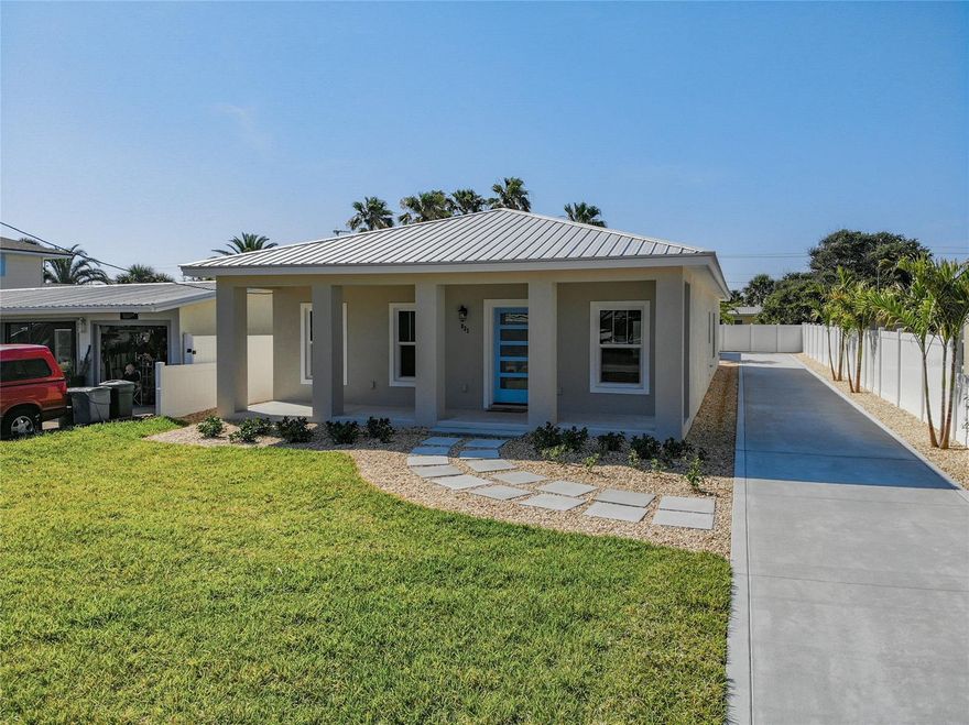 NEW CONSTRUCTION COMPLETED APRIL 2021!
3 bedroom 2 and ½ bath beach home behind Izzy’s on S Atlantic. Built by Redd Construction focusing on style and detail. When you open the front door you will be in the living room which is open to the kitchen and dining area. Right off the living room are 2 bedrooms with custom closets and 1 full bathroom.  The master bedroom and  master bath are spacious with a functional custom closet off the master bath. Throughout the house is vinyl plank flooring. The kitchen has GE monogram appliances and Cambria counter tops. The laundry room is off the dining room with built-in cabinets. When you go out to the back of the house there is an air-conditioned storage closet on the left with a tankless hot water heater. The house has a metal roof, new impact windows and doors, new A/C, outdoor lighting, wired for a security camera’s, vinyl fenced low maintenance yard with an irrigation system. When you return from your day at the beach you can shower off in the outside shower. The 2-car garage is in the back of the house with a breezeway to the back porch and entry to the house. Walk across the street to New Smyrna’s beautiful beach. Restaurants, Our Lady of the Sea Church, grocery shopping and other businesses within walking distance.  Call today to see this beautiful beach house in person or virtually! ;Water: City