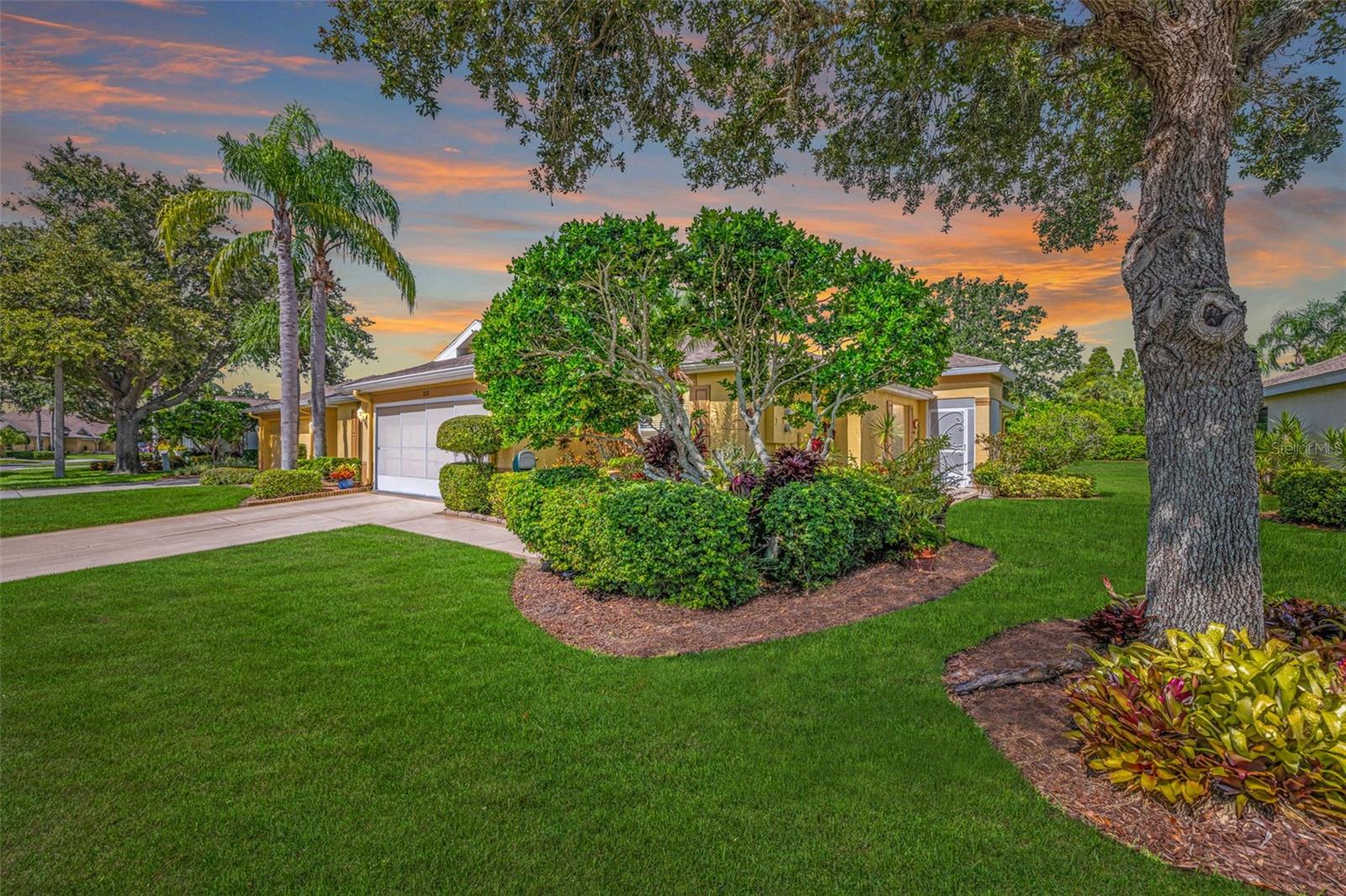 Welcome to this lushly landscaped 2 bedrooms, 2 bath condominium in Kings Point, one of West Central Florida’s premier active adult communities! Owner has nurtured her beautiful plants and now you can enjoy her efforts. With a 2-bedroom split floor plan and over 1450 sq. ft, this home provides privacy for your guests and is perfect as your retirement home or winter vacation home to escape the cold winters up north. It has an open floor plan with a separate dining area (which could be used as a den or office area) and an enclosed lanai/Florida room for morning coffee or evening beverages watching the sunset. Vaulted ceilings add to the open feeling. The kitchen has granite countertops and tile backsplash with a breakfast bar so you can chat with guests while you cook. There’s a screened front porch that welcomes your guests into the inviting foyer. Large tile floors in all areas except the living room and primary bedroom. The primary bedroom has 2 closets (one walk-in) and an updated ensuite bathroom. With an inside laundry room and a deep 2-car garage with extra storage, this home fulfills all your needs. Extra fridge in garage stays. New roof in 2023 and A/C in 2017. Kings Point and the entire Sun City Center area is golf cart friendly. You can easily get to grocery stores, Home Depot, Walmart, pharmacies, and doctors by golf cart. There’s so much included in your monthly fee such as lawn care, building maintenance, roof repair/replacement, high speed internet, cable TV, pest control, water, and sewer. This is truly carefree living. Conveniently located near beaches, medical facilities, theme parks, and major sporting venues, Kings Point is amenity rich with 5 pools, hot tubs, sauna, steam room, tennis, pickleball, lawn bowling, an 850-seat theater with shows and parties, a state of the art fitness center, a wood shop, ceramic/pottery room, sewing/quilting room, several cafes and its own sports bar! The list goes on and on! All within a private, gated community with 24 hr. manned security gates. Motivated seller so bring offers! Call today for an appointment!