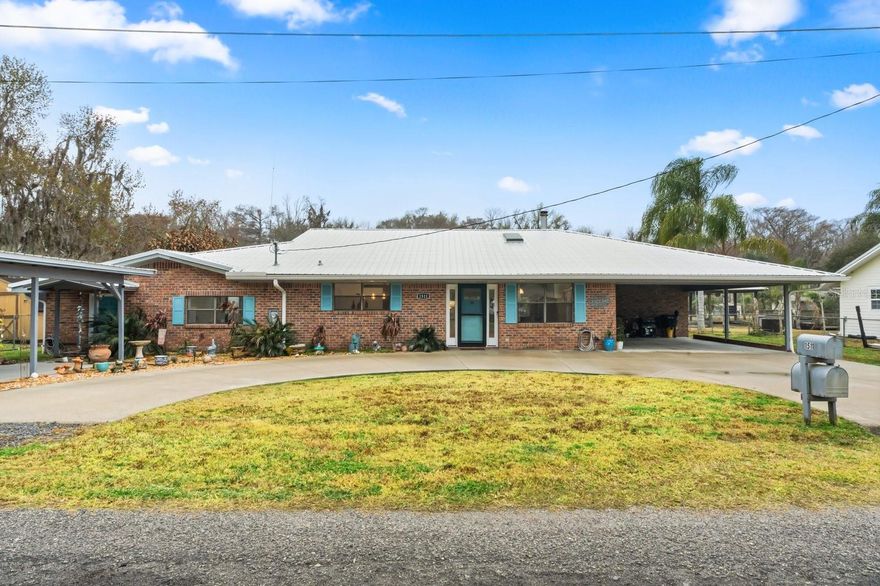 *MAJOR PRICE DROP! SCHEDULE SHOWING NOW, BEFORE IT'S TOO LATE*New Metal Roof and Gutters- 2024; New Water Heater- 2023; New Dock with Electric Boat Lift Installed**Experience the best of Florida waterfront living in this thoughtfully updated Astor canal-front home. Offering 4 bedrooms and 3 baths, this property combines relaxed river life with modern upgrades and exceptional versatility. The interior welcomes you with a bright, open feel and durable wood-style tile flooring throughout. At the center of the home, the kitchen is designed to impress with quartz surfaces, stainless steel appliances, accent lighting under cabinetry, and a spacious island, ideal for gatherings big or small. A rare and valuable feature is the separate living space, perfectly suited for multigenerational living, guest accommodations, or short-term rental use. Whether you envision hosting family or creating an income opportunity, this space adapts to your needs. The primary bedroom offers a calm retreat with a refreshed bathroom and walk in shower, while the additional bedrooms provide comfortable space for guests or family members. Enjoy peaceful mornings or evening sunsets from the enclosed and air-conditioned sunroom, where tranquil water views create a seamless indoor-outdoor connection. Outside, the property truly shines with a private dock and boathouse featuring a electric boat lift, offering direct canal access to the St. Johns River, an ideal setup for boating, fishing, and embracing the waterfront lifestyle. Updated lighting, upgraded baths, and tasteful finishes throughout complete this move-in-ready home. This canal-front property delivers flexibility, comfort, and a true connection to the water, a rare opportunity in Astor for full-time living, weekend escapes, or investment potential.