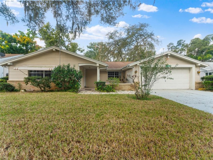 Investor Special! Don’t miss this incredible opportunity in the highly sought-after Beacon Woods community of Hudson, FL! This 2-bedroom, 2-bathroom, 1,326 sq. ft. concrete block home sits high and dry in Flood Zone X on a beautiful ¼-acre lot adorned with mature oak trees. Beacon Woods offers resort-style amenities including a heated community pool, tennis, pickleball, and basketball courts, plus a clubhouse and civic center—all for a low annual fee of just $340. A semi-private golf course winds through the community, offering both memberships and public play. Conveniently located close to Publix, Home Depot, Walmart, numerous dining and shopping destinations, Werner Boyce Salt Springs State Park, and the Gulf beaches, this property is perfectly positioned for long-term value. As you approach the home, a front patio and courtyard welcome you—ready for your personal finishing touches. Step inside to a spacious living and dining area, with two bedrooms and two bathrooms on one side and the kitchen on the other. The family room and kitchen both open to a Florida room overlooking the large, semi-private backyard with no visible rear neighbors thanks to lush native vegetation. A two-car garage with washer and dryer hookups adds convenience and storage. This property is offered strictly AS-IS for the seller’s convenience and may not qualify for traditional financing. It is in need of roof, plumbing, and general renovation work to restore it to its full potential. There is evidence of a prior roof leak affecting the family room ceiling and a plumbing leak under the kitchen sink. The hot water heater was replaced approximately two years ago. Bring your tools and imagination—this home is a blank canvas ready for your next renovation project. With solid bones, a desirable location, and great community amenities, this property offers immediate equity potential once repairs are completed.