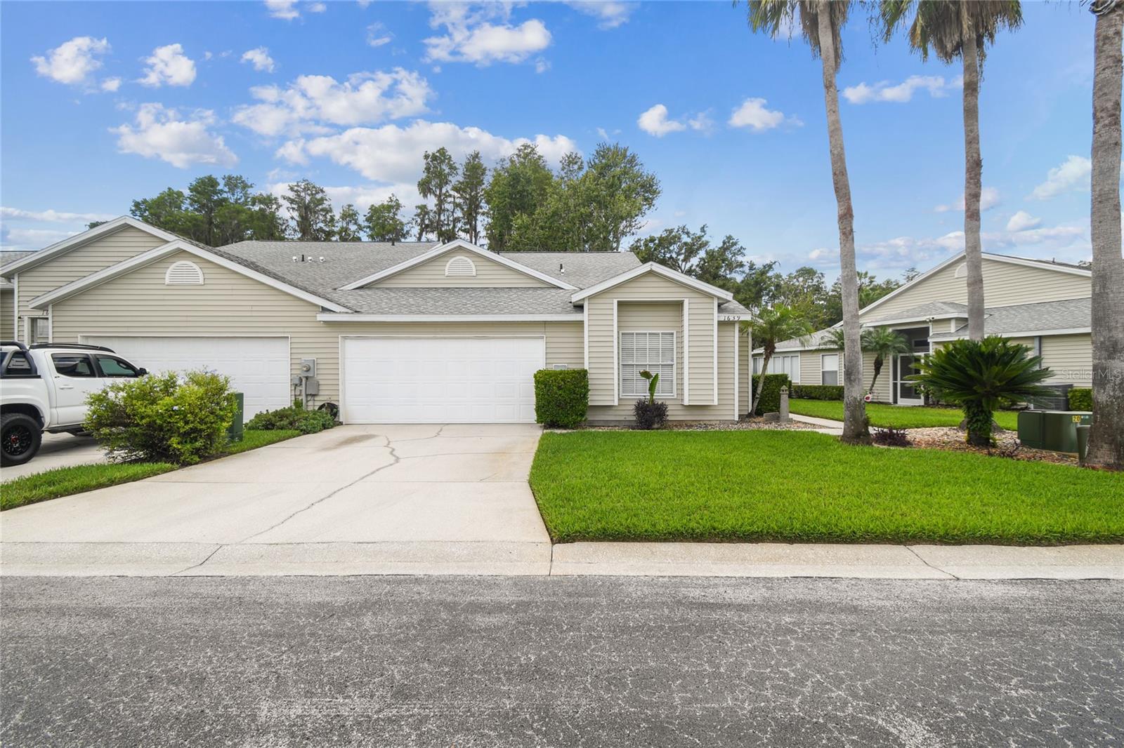 Here is your opportunity to live in a private community with access to Bird Lake in beautiful Lake Heron. Enter the gated community and you’re instantly surrounded by lush, well manicured mature landscaping. You can literally own a piece of paradise with this villa and the .82 acre lot (731’x72’) that backs to Bird Lake! You can boat, kayak and fish at your heart’s desire! Build your pathway, your deck or even a boat dock if you’d like! You’ll also have the added luxury of lawn maintenance included with your very low HOA fees – so no bulky lawn equipment needed – even though you have room with your 2-car garage. This house is High and Dry! This villa is move-in ready, with newer stainless steel appliances, new 20mm Luxury Vinyl, and carpet in the bedrooms. Enter into the family room and notice the soaring ceilings and the view! Sliders take you to your screened porch that overlooks your lush lot. This single story END UNIT Villa with two car garage leaves the feeling of living in a single family home, and provides safe living for wheelchair access, if needed. This spacious home offers a split plan that allows for privacy and a large primary suite, with room for a king bed, a sitting area and has a walk-in closet. The ensuite offers dual sinks, a garden tub and a separate walk-in shower. The kitchen offers ample cabinets, and an eating space where you can watch the wildlife and access the screened porch. The dining room is right off the kitchen and just past that is the hallway that leads to the additional 2 bedrooms, 2nd bath, laundry closet and the garage. If you want a change of scenery from your beautiful lot, you’re just a short walk away from the floating dock where you can go fishing, or simply relax and enjoy mother nature. The community also has a large community pool and spa, with a clubhouse and even a nature trail! The HOA covers the roof also, and it was replaced in 2020. Schedule your showing today!