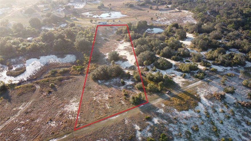 Three acres of mostly cleared natural Florida land in a quiet rural setting, featuring a mature oak tree and a mix of open space with native vegetation. Well-suited for a private homesite, with sandy soil and natural clearings already in place. Septic and well will need to be installed, with electricity available at the road. Access is via an unpaved road—please use caution when driving to the property. Some phone/GPS will have issues finding the road, please search "Lake Andrea Rd Babson Park".