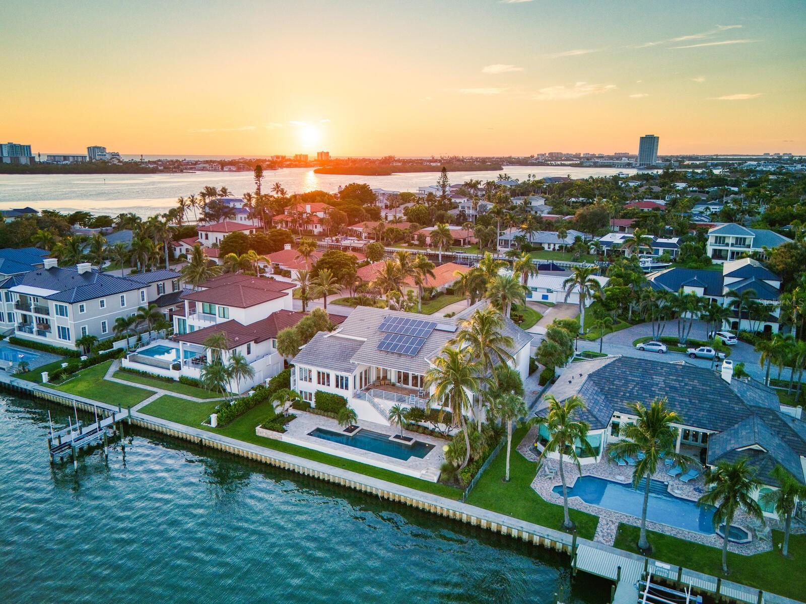 Set on the exclusive southern tip of Bird Key, this exceptional waterfront estate offers breathtaking, unobstructed views of Sarasota Bay, unmatched privacy, and a level of craftsmanship rarely seen. Designed and built by the current owners with longevity and quality in mind, the home stands as a testament to timeless architecture and enduring construction.
Elevated above the floodplain with a ground level at 9.5 feet and a main living level at 16.1 feet, this residence spans 4,618 square feet under air on the main level, with nearly 10,000 total square feet of secure space, including a 9-car garage with EV chargers, an elevator, and an expansive ground-floor flex room that must be seen to be believed.
Key Features:
• 4 en-suite bedrooms, plus a bonus room with closet—ideal as a 5th bedroom or office
• Soaring 22-foot ceilings and a light-filled open/split floor plan
• Concrete block construction on 71 pilings driven 37 feet into bedrock
• Impact-rated windows and doors, concrete tile roof, and whole-house generator
• Chef’s kitchen with water views, Thermador and Sub-Zero appliances, walk-in pantry, R/O system, and water filtration throughout
• Resort-style pool (recently renovated) overlooking Sarasota Bay, ready for your custom dock and boat lift
• Striking entry with circular paver drive and beautiful tropical landscaping framing the property
With classic modern architecture, the interiors serve as a perfect canvas for your personal design vision.
Bird Key Lifestyle:
Residents enjoy the option to join the Bird Key Yacht Club, offering boating, waterfront dining, tennis, fitness facilities, and a vibrant social calendar—from wine tastings and intellectual series to holiday celebrations and athletic events. Bird Key is perfectly positioned between the cultural energy of Downtown Sarasota and the boutique shops and restaurants of St. Armands Circle, with Lido Beach just minutes away.
________________________________________
If you're ready to have it all—privacy, luxury, location, and waterfront living—schedule your private showing of this Bird Key gem today.