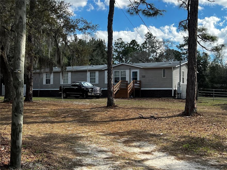 Wow! Fixer home on beautiful treed 1.50 acres. 3 Bedroom,(split plan) 3 bath MH that features  eat in kitchen ,,wood cabinets, laminate flooring, updated stainless steel appliances, range, refrigerator, dishwasher, microwave,. Family room and great room with ceiling fans, window treatments. The large Master bedroom has separate area for sitting or office. Master bath need refinishing(see pics)needs floor, drywall, etc. Inside laundry room includes washer and dryer. Backyard decking makes BBQ pleasurable while overlooking private acreage. Note:From this central location, you'll have quick access to U.S. 19, connecting you to Crystal River, Tampa, and the rest of Florida's Nature Coast. You're just minutes from local schools including Homosassa Elementary and Crystal River High,  and a variety of small businesses that give the area its hometown charm. For lifestyle and leisure, you'll enjoy proximity to the Homosassa River and Gulf of Mexico for boating and fishing, as well as golf courses, parks, and nature preserves. Everyday conveniences are right around the corner...grocery stores, hospitals, shopping, and medical offices along with popular restaurants, waterfront dining, and local entertainment. Flood Zone X offers peace of mind, and the lot's size and location make it a perfect canvas for your vision. Opportunities like this are rare...spacious land in a neighborhood setting, with so much nearby to enrich daily life.