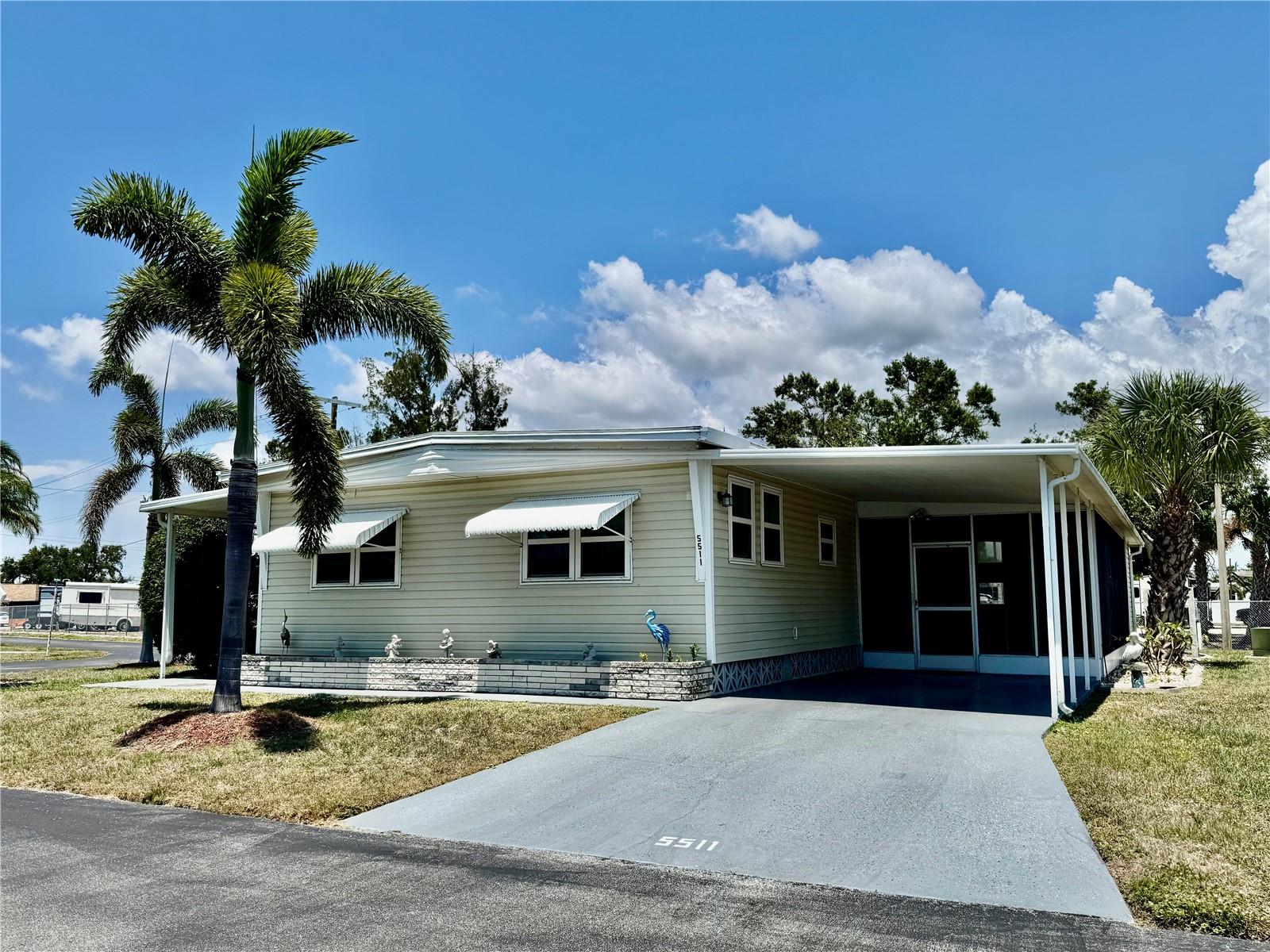 2 BED, 2 BATH MOBILE HOME IN 55+ COMMUNITY. This home comes with TWO covered carports and TWO lanai's. Water Heater (2023). All new plumbing and drains (2023). New carpet in front lanai. New electric box (2024). This furnished home is ready for you to start enjoying the luxury of Florida living! Own your land! Chateau Village is a land-owned community with low HOA fees of just $210/month which includes water, trash, cable and internet. The park offers a community pool, shuffleboard courts and a clubhouse with numerous activities. Pet friendly! Close to shopping, restaurants, and beaches.