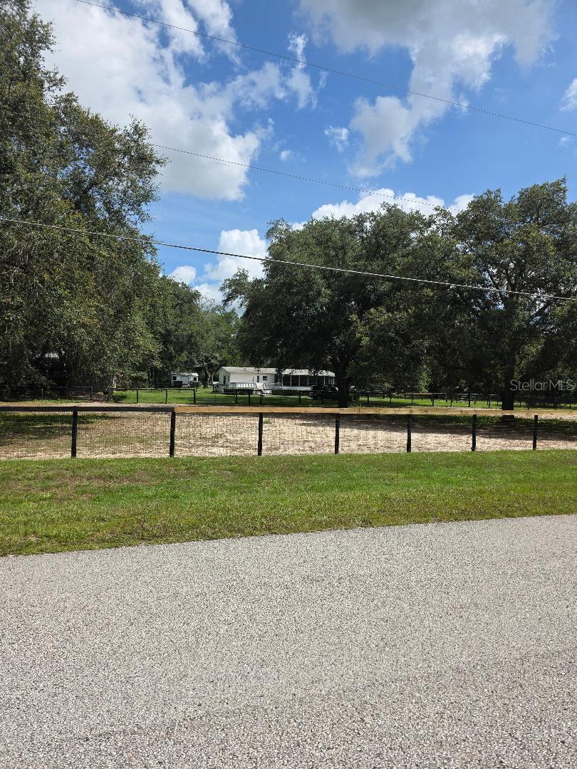WELCOME HOME! Room for you and your horses. Just 2 miles from WEC! As you come through the gate, you see 3 Board Fence paddocks and a 4 stall Barn with electric, water and a Tack Room. At the end of the Center Row is a wash rack.
Your domain is an open Livingroom/dining room/Kitchen space. The Livingroom is bathed in light with sliders to a rear deck, and a Stacked Stone wood burning Fireplace! and Dining room has sliders to enclosed front porch. The Kitchen has tumbled marble back splash and 2 pantries. Large Primary Bedroom has walk-in/organized closet and Large en-suite bath has huge walk-in shower with 2 shower heads, double sinks and linen closet. Inside Laundry room. Back yard boasts a large shed. wishing well that covers well tank and new drain field. Washer/Dryer do not convey.