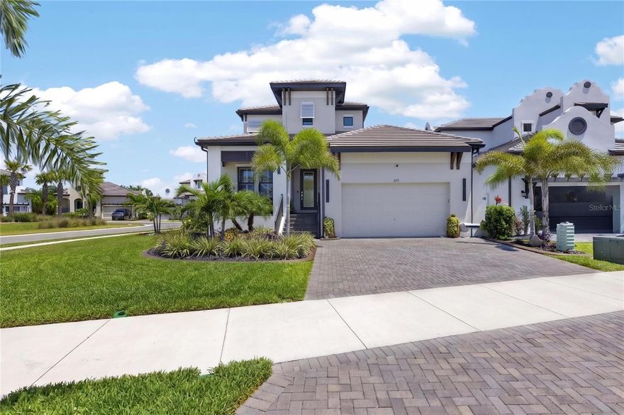 Luxury Pool Home in Antigua Cove | 1075 Seagrape Dr, Ruskin, FL 33570 | 3 Bedroom | 2.5 Bathroom | 2,571 sq ft | 2 Car Garage | Gated | Fenced

Welcome to coastal luxury living in the exclusive gated community of Little Harbor. This highly upgraded 3-bedroom, 2.5-bathroom home with a 2-car garage and 2,571 sq ft is perfectly positioned on a premium corner lot in Antigua Cove, offering designer finishes, a resort-style pool, and exceptional indoor-outdoor living.

From the moment you arrive, you’ll notice the tile roof, pavered driveway, curbed landscape beds, and inviting front porch with a wood inset ceiling. Step through the glass front door into a thoughtfully designed interior featuring wood plank tile flooring throughout, plantation shutters, crown molding, tray ceilings, recessed lighting, and custom architectural wall detailing. The open floor plan offers a main-level office/flex room, a spacious loft upstairs, and a split-bedroom layout for privacy.

The heart of the home is the gourmet kitchen, showcasing an oversized island with seating, pendant lighting, quartz countertops, designer backsplash, farmhouse-style sink, stainless steel appliances, gas cooktop with a custom hood, and TWO full-sized built-in ovens—one featuring smart technology with convection and air fryer capabilities—perfect for entertaining or everyday convenience. White cabinetry with crown molding and a large walk-in pantry with built-ins provide both style and function.

The primary suite is a private retreat with tray ceilings and serene backyard views. The spa-like ensuite features dual vanities with framed mirrors, an oversized glass-enclosed shower with bench and niche, and a custom walk-in closet with premium built-in organization system.

Step outside to your own private resort. The covered and screened lanai includes a ceiling fan and a fully equipped outdoor kitchen with bar seating, grill, refrigerator, and exhaust fan. Overlooking it all is a heated, saltwater infinity-edge pool and spa, surrounded by elegant travertine pavers and accented by stunning fire features, creating the ultimate outdoor ambiance. The fully fenced yard enhances privacy and usability.

Located in Antigua Cove, residents enjoy access to a two-story clubhouse, fitness center, event space, and resort-style pool overlooking the marina. The greater Little Harbor community offers waterfront dining, a tiki bar, tennis courts, a private beach, and a pier on Tampa Bay, all with breathtaking sunset views of the Tampa and St. Petersburg skylines.

Conveniently located near US Hwy 41, this home provides easy access to Tampa, St. Petersburg, and Sarasota, with nearby international airports, major sporting venues, entertainment, Seminole Hard Rock Hotel & Casino Tampa, and world-renowned Gulf Coast beaches.

Furniture is negotiable. This one-of-a-kind home blends luxury, comfort, and lifestyle—schedule your private showing today.