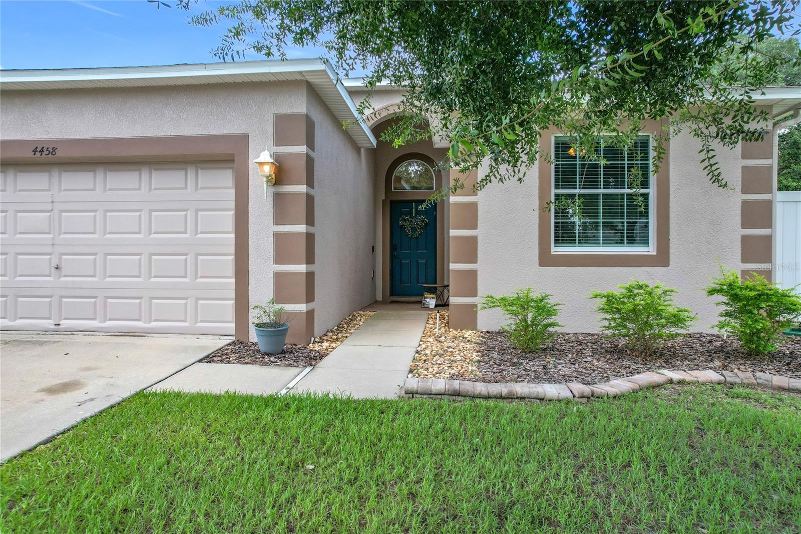 This beautifully renovated 3 bedroom 2 bath home offers a split floor plan and sits on on oversized lot. The updated kitchen offers quartz countertops, marble backsplash, soft close cabinets, newer appliances and a custom built island. A stylish touch/tap faucet adds both convenience and elegance. The open concept floor plan is perfect for entertaining. The home features ceramic tile floors designed to look like wood. The primary suite is like your own personal spa. It features two closets and an updated vanity. You will fall in love with the luxurious walk in shower with dual shower heads, two benches and built in Bluetooth speaker. The AC and duct work are new. The home is surge protected, all breakers have been replaced with safety breakers. There is a covered patio that overlooks a large privacy fenced backyard. This community has sidewalks and a community pool.