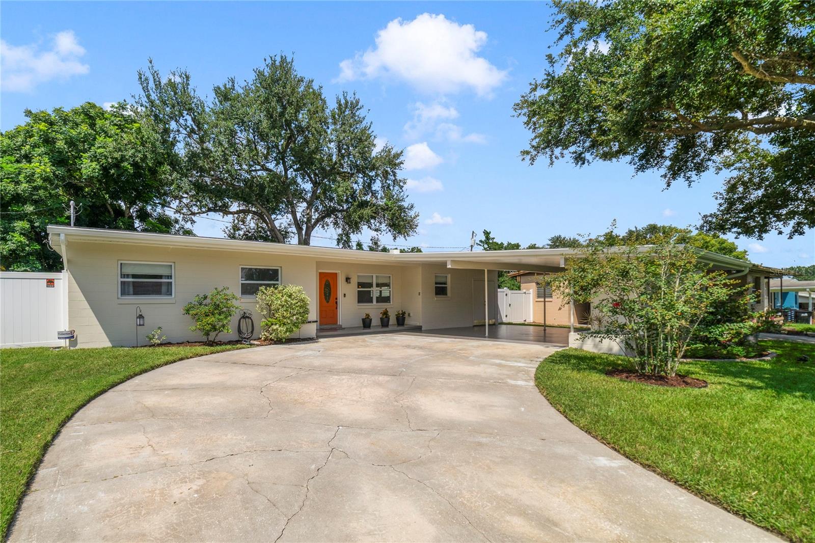 Timeless Charm Meets Modern Luxury in This Fully Renovated Mid-Century Modern Gem! Step into a beautifully reimagined piece of history—this stunningly renovated mid-century modern home is a true showcase of thoughtful design and craftsmanship. Every inch of this 3-bedroom, 2-bath residence has been meticulously updated, blending vintage charm with modern elegance to create a warm and inviting sanctuary. Nestled in the heart of the vibrant and growing SoDo district, just 4 miles from downtown Orlando and only 7 miles from Orlando International Airport, you’ll find the perfect combination of peaceful neighborhood living and urban convenience. As you walk through the front door, you're immediately welcomed by an expansive open floor plan, drenched in natural light from large, newly remodeled windows that draw the outside in. The original terrazzo flooring stretches throughout most of the home, preserving a touch of the 1950s while seamlessly complementing the sleek, contemporary finishes. The kitchen is a true showstopper—light, airy, and designed to inspire. Featuring soft cream Shaker-style cabinetry, the space exudes a sense of character rarely found in modern renovations. Gentle-close drawers and cabinets offer abundant storage, and a generous pantry closet. Gorgeous Dallas White granite countertops provide ample workspace, while a bar seating area for two invites casual conversation or morning coffee rituals. All almost new, top-of-the-line Samsung stainless-steel appliances—including a refrigerator, stove, dishwasher, and disposal—along with a sleek Whirlpool hood vent, complete this dream kitchen. Just off the kitchen, a cozy rear sunroom becomes a retreat all its own. Anchored by a striking all-brick fireplace and finished with rich wood-look tile and brand new sliding glass doors, this space is ideal as a dining room, reading nook, or even a serene home office. It’s the kind of room that instantly feels like home. Both bathrooms have been tastefully renovated with spa-like finishes. The primary suite features a private bath with a luxurious walk-in shower, complete with seamless glass doors and soothing pebble rock flooring—your very own at-home escape. Outside, you'll find a peaceful, fenced backyard—perfect for weekend gatherings, family playtime, or simply relaxing under the Florida sky. Whether you're a lover of mid-century design, a first-time homebuyer, or someone looking for a thoughtfully renovated retreat near the heart of Orlando, this home is a must-see. Come experience the rare blend of history, style, and comfort—your modern oasis awaits. UPDATES: Roof 2020, Fence 2020, Water Heater 2023, Backyard irrigation 2023, Septic 2023, Rear windows in bedrooms and slider 2022, All other windows replaced between 2016-2019, AC 2016, Exterior paint 2025, Back concrete patio 2023, Updated electrical by previous owner.