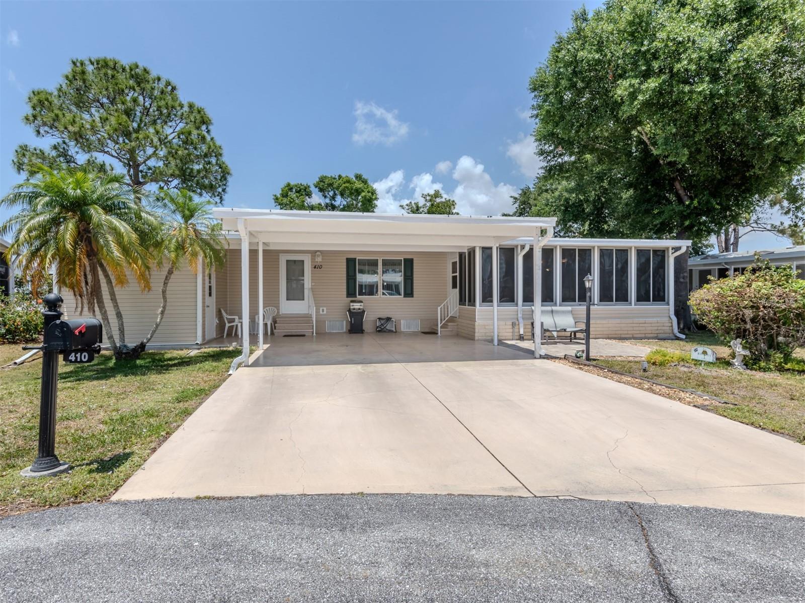 Welcome to your dream retreat in the heart of The Village at Riverwalk, North Port, Florida. Nestled on a serene cul-de-sac, this meticulously maintained 3-bedroom, 2-bath Palm Harbor manufactured home offers 1512 square feet of turnkey furnished bliss. Its unique sideways positioning enhances curb appeal, complemented by a spacious double carport and a generously sized Florida room with acrylic windows, ensuring year-round comfort and enjoyment.
Step inside to discover a chef's delight in the large cook's kitchen, boasting ample cupboard and counter space along with a convenient pantry. Vaulted ceilings amplify the open and airy ambiance, while laminate flooring throughout the living and bedroom areas adds a touch of elegance. The guest rooms feature walk-in closets for added convenience, while the master bath showcases a luxurious walk-in linen closet, an extra-long vanity, and a stunning tile walk-in shower. Beyond the comforts of home, residents of Riverwalk relish in a wealth of amenities including a kayak launch for aquatic adventures, shaded walking trails amidst mature trees, and a vibrant community spirit that fosters endless opportunities for recreation and relaxation. Experience the epitome of Florida living in this inviting haven, where every detail has been thoughtfully curated for your utmost enjoyment.