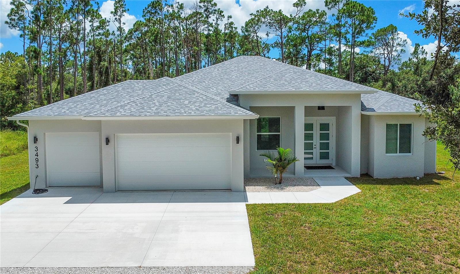 Discover the perfect blend of modern luxury and peaceful tranquility at 3493 Elkrem Ave, North Port. This brand-new 2025 construction sits on an oversized 3.1-acre wooded lot, offering unmatched privacy with no HOA fees and no CDD fees, giving you complete freedom to enjoy your property your way.
This thoughtfully designed home features 3 bedrooms, 3 bathrooms, and a private office, built with top-quality finishes and energy-efficient upgrades, including impact-resistant insulated windows and doors, impact-resistant insulated garage doors, and spray foam roof insulation.
Inside, you'll love the water-resistant laminate flooring in the main living areas and porcelain tile in the bathrooms, combining style with durability.
Plenty of room for a pool, RV, or boat, plus all the space you need to live, work, and play. Just minutes from shopping, dining, and Gulf Coast beaches, yet tucked away in your own wooded sanctuary.
Don't miss this rare opportunity to own a brand-new home on over 3 acres with total freedom!