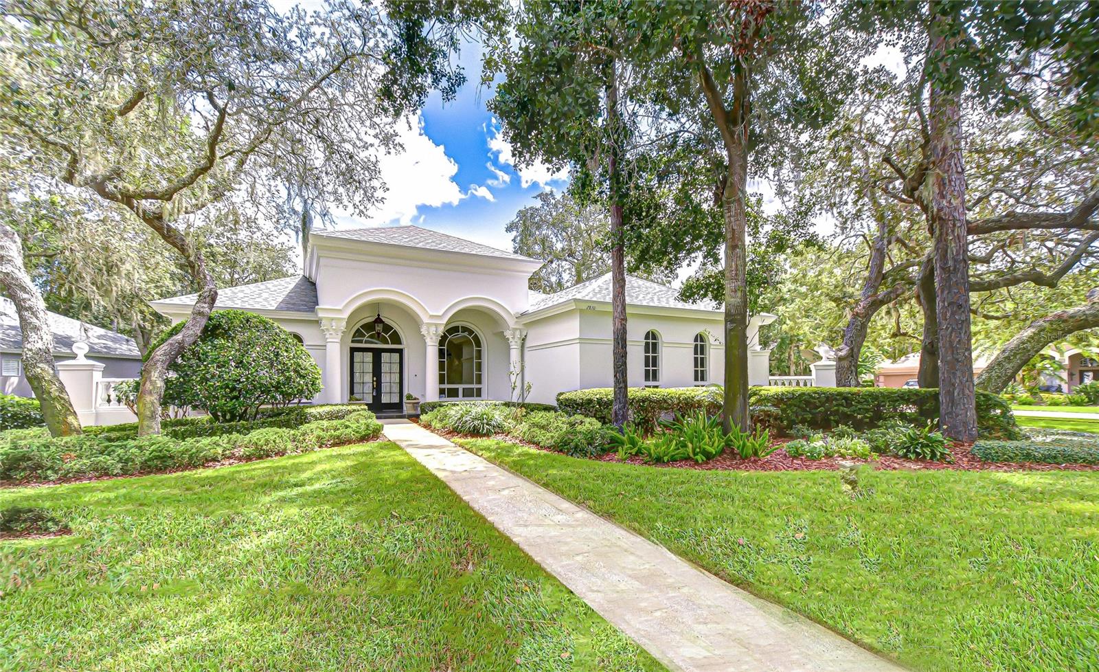 One or more photos have been virtually staged. Welcome to this beautifully crafted, custom built, single-family residence by premier builder Marc Rutenberg. Located in the distinguished and sought-after community of Grey Oaks. This thoughtfully designed home features 3 spacious bedrooms, 3 full bathrooms, and a versatile 12x17 bonus room—ideal as a 4th Bedroom, home office, guest suite, or media room. Enter through double doors into an impressive modern floor plan featuring a formal living room, separate dining room with built-in display cabinet and serving bar. In addition, the spacious great room flows seamlessly into the pristine kitchen which boasts abundant cabinetry, solid surface counter tops, walk-in pantry, table-height snack bar and bright casual dining area. The mitered windows all overlook the shimmering pool and attached spa. The split bedroom layout ensures privacy for all. A tranquil primary suite, separate from guest rooms, features a peaceful view of pool, en suite bath with his & hers vanities, dressing table, large walk-in shower, separate garden tub, toilet room and an expansive walk-in closet. A few of the many additional features are 12’ ceilings, crown molding, recessed art niches, built-in book shelves, overabundance of storage, beautifully appointed and substantial mantel above the wood burning fireplace in great room. Perfect for Florida living, the screened enclosed lanai with brick paver deck has a kitchen and plenty of room for all your favorite pastimes. Situated on an oversized corner homesite, this home is graced with lush mature landscaping, stately oak trees and enjoys added privacy with only one adjacent neighbor and a peaceful pond at the rear. Tucked away in a quiet, secluded setting, conveniently close to shopping, dining, Brooker Creek Preserve, beaches and everyday amenities. This home offers the perfect blend of luxury, comfort, and location. Contact us today for a complete list of additional features and your private tour of this treasure.