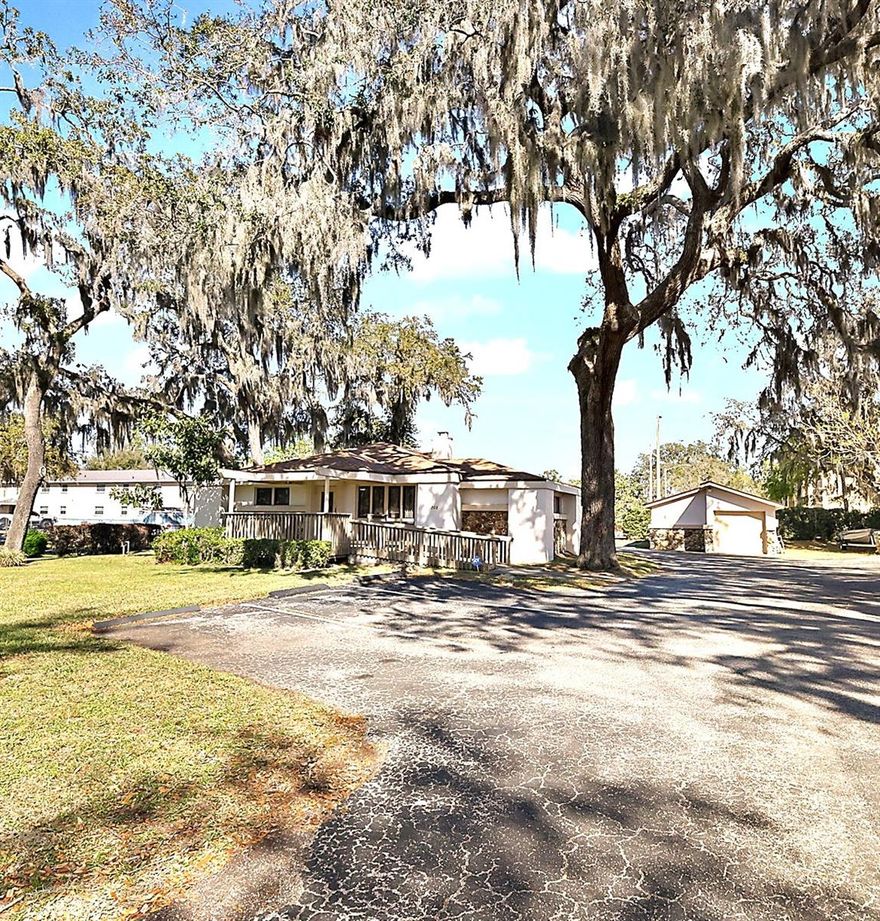 Well maintained, CONVENIENTLY located commercial building provides plentiful PARKING and high visibility for your new or expanding business. With 2,169 square feet, the primary building offers a large welcoming RECEPTION AREA, five spacious offices, three ceramic tile bathrooms, space for a conference room, and an executive office suite with sophisticated wood paneling, built-in bookshelves, and ensuite private bath and shower. Detached 528 square foot garage provides plentiful, climate controlled STORAGE. Located approximately 250 feet from the intersection of Highway 441 and Lee Street, the property benefits from an average daily traffic count of 34,000 vehicles at this intersection, according to the Florida Department of Transportation. Situated on a spacious corner lot, it provides 12 ON-SITE PARKING SPACES, 253 feet of frontage on Lee Street and Oak Terrace Drive, with excellent VISIBILITY and access from both city streets. The surrounding area hosts a mix of businesses and residential homes. Surrounding businesses include Citizens First Bank, Center State Bank, Wells Fargo, UF Health Leesburg Hospital, Central Florida Health Alliance, and Beacon College. Zoned for Residential/Professional Office use, the property offers potential for various uses including professional offices, medical facilities, and institutional purposes. The building is exceptionally well-maintained with attractive façade and landscaping, a new roof (2024), and city utilities. Leesburg's population has experienced significant growth in recent years, making this an ideal location for your business.