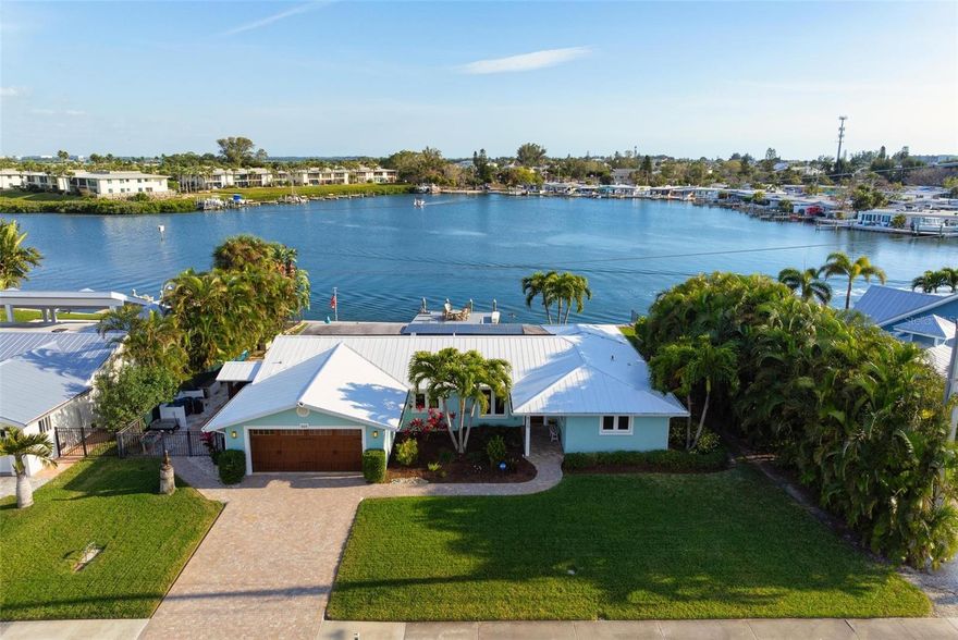 Experience the epitome of island living in this stunning waterfront haven nestled within the coveted Key Royale community. Boasting meticulous renovations by Shoreline Builders in 2018, this turnkey furnished home spans 2,100 square feet across an 11,200 square foot lot. With 100 feet of waterfront and a 384 square foot dock, access to Tampa Bay and the Gulf of Mexico is at your fingertips. The residence features a split floor plan with two generous en-suite bedrooms, including a primary suite with access to the covered patio and outdoor shower. High ceilings accentuate the kitchen and living area, adorned with quartz counters and an eat-in island bar. Glass sliders beckon you to the patio and pool area, offering beautiful views to the intercoastal waters and stunning sunrises. Enhanced by impact-resistant windows and doors (2018), solar panels (2021), and a metal roof (2016), this home ensures both comfort and sustainability. Other highlights include a newly resurfaced pool (2020), a 2-car garage for plenty of storage or a golf cart, and much more. Key Royale residents have the option of joining the private Key Royale Golf Club, which has the island’s only golf course, as well as dining and social activities. Separate membership is optional. Embrace the quintessential island lifestyle with effortless access to Anna Maria Island's pristine beaches and vibrant social scene. Set sail from your backyard for captivating sunset cruises and indulge in the serenity of waterfront living. Don't miss the chance to make this paradise your own – call today for a private showing.