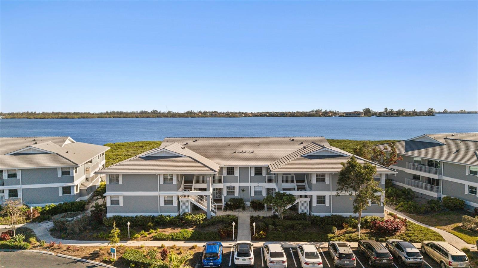Discover your personal oasis in this exquisitely renovated, first-floor bayfront residence within the coveted Perico Bay Club. Panoramic vistas of Palma Sola Bay and the Intracoastal Waterway create a serene backdrop for this two-bedroom, two-bathroom haven. Indulge in spa-like bathrooms featuring porcelain and marble finishes, custom beadboard cabinetry, and ambient accent lighting. The redesigned kitchen, boasting quartz countertops and a stunning glass tile backsplash, opens seamlessly to the breathtaking view. Step directly outside to the residents' pool and spa. Perico Bay Club, a gated community, offers a wealth of amenities including a modern clubhouse where you will find the fitness center, library, two meeting rooms and community kitchen. Nearby are the pickleball and tennis courts and a junior Olympic-sized pool. Cross the Manatee Bridge and you’re on Anna Maria Island with its sugar sand beaches and quaint island charm. Just minutes away you experience the natural beauty of Robinson Preserve with kayaking, walking trails, and bike paths. Wait no longer! It’s time to start living your best life.
