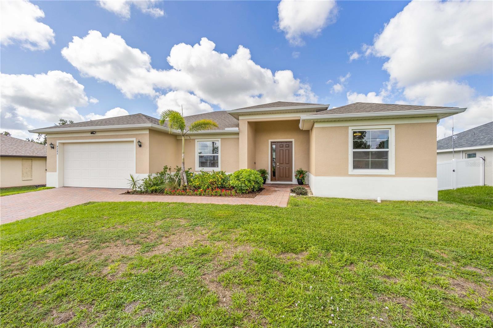 Discover this charming 3 Bedroom with a DEN, 2 Bath, better-than-new home on close to ¼ ACRE! The PAVER driveway welcomes you to the front entry and as you step into the foyer your eyes will be attracted to the beautiful 10’ CEILINGS, 8’ DOORS, and NATURAL LIGHTING emerging from the extensive DOUBLE-PANED ENERGY EFFICIENT WINDOWS. The OPEN CONCEPT floorplan hosts an impressive kitchen with 42” WOODEN upper cabinets, QUARTZ countertops, STAINLESS STEEL appliances with counter depth refrigerator, tile BACKSPLASH, beautiful PENDANT LIGHTING, Breakfast bar with SHIPLAP, and eat-in-dining area. A true SPLIT floorplan, the Owner’s Suite offers 2 WALK-IN-CLOSETS and a BARN DOOR opens to the ensuite bath with 2 sink GRANITE VANITY, large shower and LINEN CLOSET. Bedrooms 2 and 3 are on the other side of the home and the den is right off the front entry with DOUBLE FRENCH DOORS currently being used as a 4th bedroom. Some other added features include blinds on all windows, full IRRIGATION SYSTEM, electric garage door with opener, EXTRA REFRIGERATOR IN GARAGE, and SMART HOME PACKAGE with BLINK SECURITY SYSTEM. North Port is one of the #1 growing areas in the nation and is close to the Atlanta Braves Spring Training. Minutes to the North Port Aquatic Center, a water park featuring a 25-meter stretch pool, three water slides, and a lazy river, you are also a short 20 minute drive to area Gulf Beaches and close to EVERYTHING...US-41, I-75, schools, nature parks, and plenty of shopping and dining!
