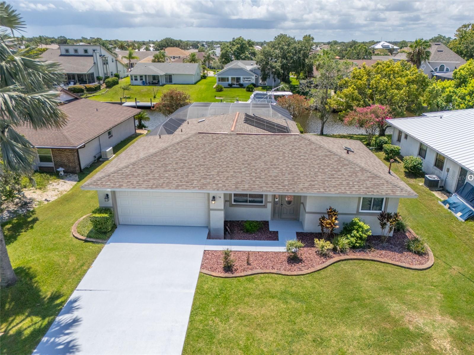 Charming 3/2/2 solar-heated pool home located on a quiet cul-de-sac situated on a saltwater canal in the desirable sailboat section of Palm Coast. Open floor plan. Attractive laminate flooring in the living, dining, kitchen & spacious eat-in kitchen area. Fresh paint inside & out, including the walkway & driveway. AC 2021 Roof & skylights replaced in 2019. Windows 2014. Pool pump replaced in 2025. Aluminum pool enclosure replaced in 2017. A lovely paver walkway takes you down to the boathouse & dock with composite decking, which was replaced in 2022. Electricity (50amp), a separate circuit & water are located at the dock. Boat lift. An 8-minute boat ride to the Intracoastal. Covered lanai area. Extended patio. No homeowner's association. NO fixed bridges.