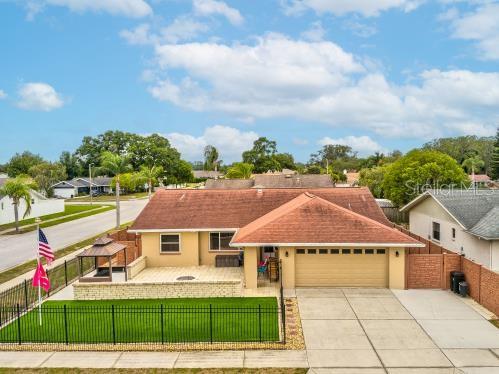 Welcome to Deer Park, bring the dogs, bring the kids, bring your friends...This is True Florida Living. Superior corner lot that is Pet and Kid friendly with artificial turf lawn in front and back, 21' x 30' front porch with fire pit and two built in grills, 12' x 22' rear patio, fire pit, full tiki bar, entertainment gazebo and plenty of room for the pets and kids to play.
This 3 bedroom 2 bath and 2 car garage split home has a open floor plan with a large 14 1/2' x 16' living room with cathedral ceilings and a huge 16' x 21' family room that leads out to the entertainment patio. The kitchen is accessible by the living room and family room and has a pass thru window to the Patio. Master bedroom features walk-in closet. Bathroom has a jacuzzi tub and the bedrooms comfortably fit king or queen beds. Surrounded by top of the line fencing for security and peace of mind. Top of the line Trane air conditioner new in 2017 and roof and gutters in 2014. Personal property staying: all appliances, 3 refrigerators, Commercial Kegerator, washer/dryer, 3 grills, 2 TV's, 2 outdoor fans, 2 tiki torches, 4 ring cameras. Deer Park is the last affordable subdivision in the Trinity region. Walking distance to A rated Deer Park Elementary School, 30 minutes to Tampa International Airport and 30 minutes to the beaches.