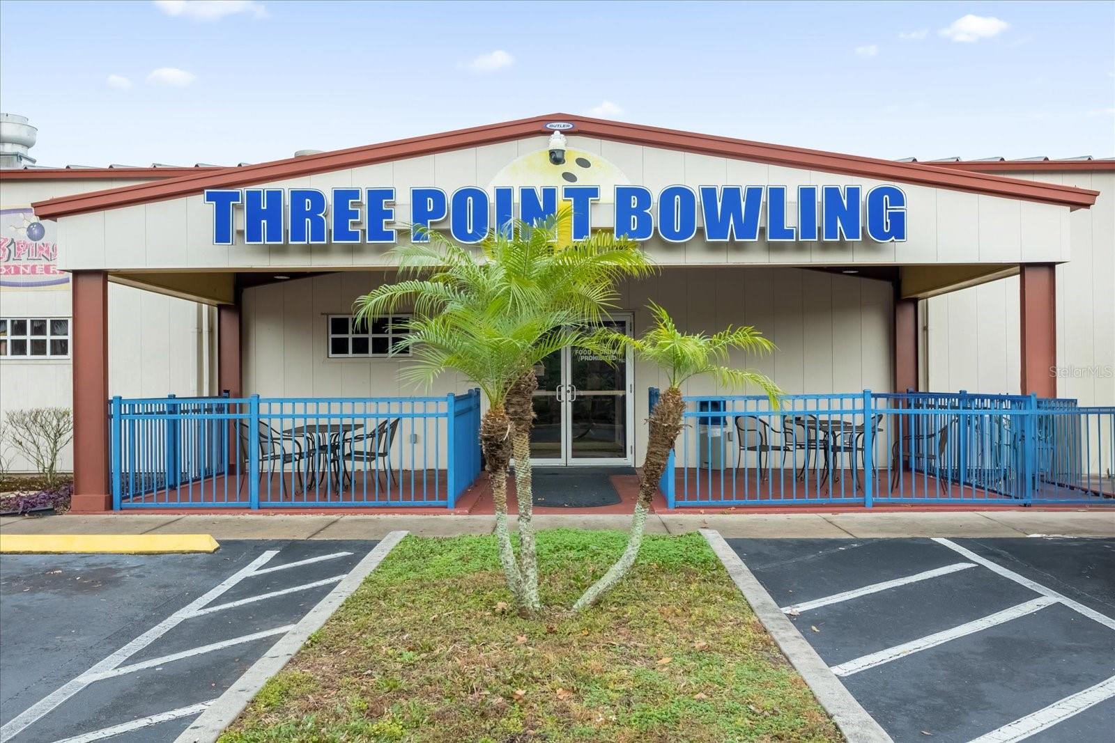 Strike a deal and PIN this down well. Roll the ball and score high buying this property. On 4.72 acres of PRIME commercial property zoned AC-1 off Hoffer/ NARCOOSSEE RD. and Golden Rod, The Three Point Bowling Center is a Sports and Entertainment center offering real scoring systems, synthetic lanes, pinsetters, LED lane, capping lighting, gutter and bumper systems with balls, ball racks, pins, and hoods matching the interiors. The 2009-built alley boasts 18,750 heated sft over a 19,247 sft total building size. Comprised of 16 lanes with new flooring, this center is FULLY OPERATIONAL and takes pride in its lanes' excellent condition. Polished, the previous lane pinewood floor- so shiny and beautiful- was refitted to build bars and tables in the main bar offering a wide range of beverages and delicious food served from the all-equipped modern kitchen. There's also a video arcade with games and billiards, and a front office reception for shoe rentals. This place caters group events, Holiday/Birthday Parties & Fundraising Events. An outdoor sports bar complements the bowling alley & offers an area for smoking and hanging out for a breeze, a puff and barbecue area near the pond. Ample well-lit parking spaces in the private paved front lot & additional parking in rear and side. Let the THE GOOD TIMES ROLL! Alternatively, due to the size of property and acreage, any school or warehouse or sports arena/complex, ball field may want to take-over this space for a possible future use. MCO Airport is a 12-min drive, so close to the Airport. Hoffner is also Narcoossee road. Pls DONT DISTURB any staff or tenants. Direct all questions to Listing Agent.