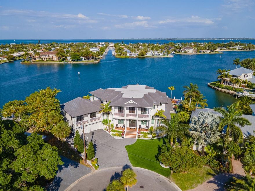 Anna Maria luxury at its finest!  This 5,921 square foot, spectacular bayfront estate provides the perfect combination of privacy and coastal elegance in the center of the tropical paradise that is Anna Maria Island. Whether it is boating you desire, beaches, or both, this home has everything you need to live the island lifestyle. When you enter this beautiful home, you will be enchanted by the amazing views of the crystal blue waters of Bimini Bay that greet you from every room in the home.  This sprawling 2-story home contains 6 bedrooms, 5 bathrooms, 2 half bathrooms, and 2 living rooms.  The home also has an entertainment room, 2 gas fireplaces, multiple balconies, and a two-and-a-half car garage.  The finest touches and finishes encompass every corner of this home from the custom Amish cabinetry to the detailed ceiling and trim to the walnut flooring and beyond.  This home shows like a priceless work of art!  The master suite is impressive with its built-in, automated shades, exquisite ceiling, plush seating area, private lanai, complete with gas fireplace, and expansive closet with dedicated washer and dryer.  The gourmet kitchen also doubles as a centerpiece to the home with its spacious 16-foot island complete with galley sink, quartz countertops, Dacorappliance package, Miele dishwasher, and walk-in pantry.  Connected to the kitchen, a butler pantry includes Sub-Zero Wolf refrigerator and freezer doors, Perlick ice maker, Cove dishwasher, and sink.  Keeping in line with the luxurious nature of this home, it also is a smart home in every sense of the word with its Lutron automated shades and lighting.  Stepping outside the home, you will fall in love with the lush tropical landscaping and artificial turf lawn, which provides that look of perfection combined with the ease of minimal maintenance.  For the boating crew, the two docks located on a deep-water canal provide plenty of space to keep your boats easily and conveniently accessible and ready to use at a moment’s notice.  The outdoor living space includes a total of four covered patios, a fireplace, outdoor kitchen, infinity edge pool and spa, and even a putting green complete with realistic sand pit for golf enthusiasts.  Not only are the indoor and outdoor finishes and fixtures of this home spectacular, but this home comes fully furnished with beautifully appointed custom furniture, upholstery, and window treatments.  The coastal elegance of this home even earned this home a Best in Living award by the National Association of Home Builders.  Please call for your private showing today.  You will not want to miss out on your chance to own one of the most elegant, unique, and exquisite homes on Anna Maria Island!