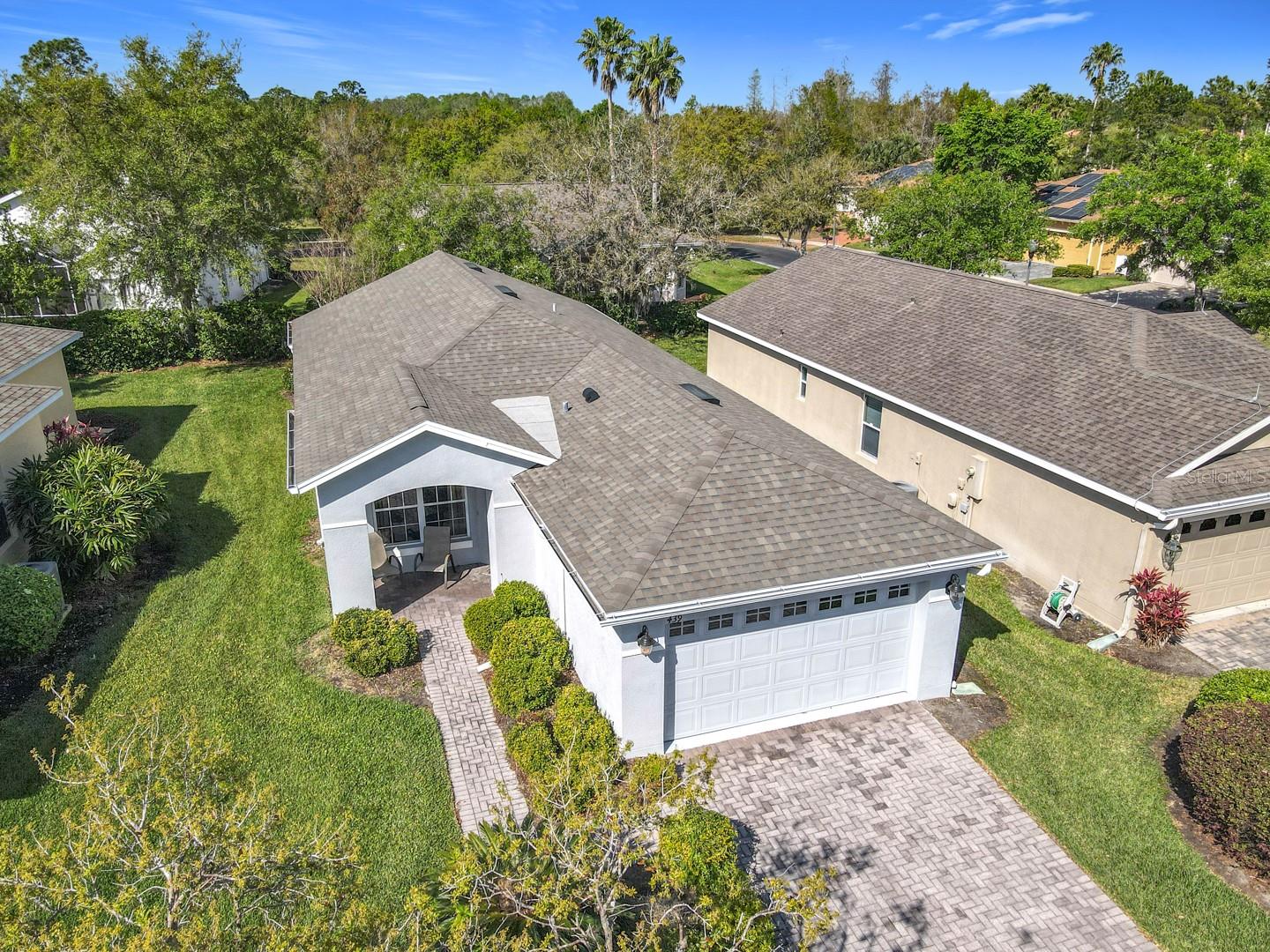 Charming Chardonnay model featuring 2 bedrooms and 1 bath with an OPEN FLOOR PLAN, vaulted ceilings, and abundant natural light. A huge EXTENDED and COVERED lanai extends the full length of the home, offering a perfect space for relaxation or entertaining, complete with privacy trees and hedges for a secluded retreat. ROOF was replaced in 2016. The living and dining room combination boasts lush carpet, creating a cozy atmosphere. The kitchen is well-appointed with tall cabinets, HARDWOOD flooring, Formica countertops, a closet pantry, and a BREAKFAST BAR overlooking the dining area, making it easy to engage with guests. The PRIMARY SUITE includes a spacious walk-in closet and an attached ensuite bath with a tub and shower combination and raised vanities, conveniently accessible from the hallway for guests staying in the second bedroom located toward the front of the home. This home also features a one-car garage with a dedicated laundry area and additional storage space for your washer and dryer, which are included in sale. The newly painted one-car garage is spacious enough to accommodate a vehicle and two golf carts. HVAC replaced in 2016. EXTERIOR PAINTED IN 2020. Call today to schedule your private viewing of this perfect starter home for someone seeking an active lifestyle in a vibrant community filled with endless amenities and activities to enjoy! Solivita's amenities include: - a manicured SOFTBALL diamond & field - 36 holes of CHAMPIONSHIP GOLF that can be played by joining the Stonegate Golf Club or paying as you go - 2 STATE of the Art AMENITY centers with updated exercise equipment, yoga studio & meeting rooms - 3 restaurants - 14 HEATED POOLS - 17 PICKLEBALL courts - 9 TENNIS courts - 4 BOCCE BALL courts - 4 SHUFFLEBOARD courts - 3 HORSESHOE pits - a BILLIARDS room - miles of bike paths - 2 DOG PARKS (Small & Large Dogs) - Corn Hole - Tot Lot PLAYGROUND - COMMUNITY GARDEN - over 250 resident clubs. The HOA: - maintains the LANDSCAPING & IRRIGATION systems in the common areas as well as at individual homesites - maintains the roads throughout the community - PROVIDES SECURITY with gate guards and mobile patrols including the Polk County Sheriff - allows AUTOMATED GATE ACCESS for residents via license plate readers - provides residents with Fiber Optic Internet & TV service.***Poinciana Lakes Plaza is a MAJOR NEW SHOPPING CENTER that opened directly across from the Solivita Main Gate in Summer of 2024. It features Sprouts Grocery, TJ MAXX, Ross, Burlington, Rack Room Shoes, 5 Below, Ulta, Outback, First Watch, 5 Guys, Urgent Care, Dentist, TD Bank, Petco & Hair Cuttery PLUS MORE TO COME.***