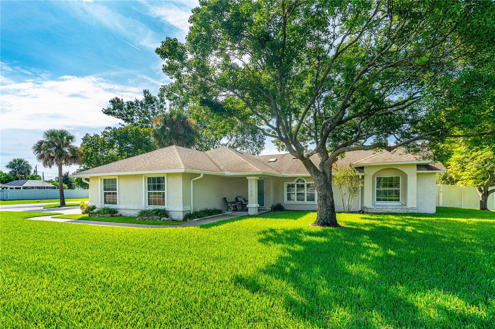 Discover the perfect blend of comfort, functionality, and opportunity with this custom-built block home situated on a spacious corner lot in the heart of Edgewater. Designed with an open floor plan, this residence offers both practicality and charm, making it ideal for a variety of lifestyles. Step inside to find an interior that seamlessly connects the living, dining, and kitchen areas—perfect for everyday living or entertaining guests. The home features a two-car garage with an oversized driveway providing ample storage and parking space, along with an enclosed rear lanai that boasts an insulated roof. This versatile space is a true highlight, ideal for use as a sunroom, hobby area, or a private home office for remote work. The property continues to impress with a fenced rear yard offering privacy and security. A utility shed is included, providing convenient storage for beach gear, garden tools, or outdoor equipment. The generous corner lot creates extra breathing room and curb appeal, with plenty of space for landscaping or personal touches. What makes this large corner lot truly unique is its prime location on SR 442/Indian River Boulevard. While currently a residential home, the zoning allows for conversion to a residential professional office. This opens the door to endless possibilities for small business owners, consultants, or personal service providers seeking a convenient and highly visible location in a growing community. This home offers a blend of comfort and opportunities in a fantastic location that is just minutes from the beach and is connected to the regional rails to trails statewide paved trail system. Also close to the Indian River with great waterfront parks and boat launching facilities. Southeast Volusia area is also known for good shopping and great restaurants. Schedule your private showing today and explore all that this unique Edgewater property has to offer!