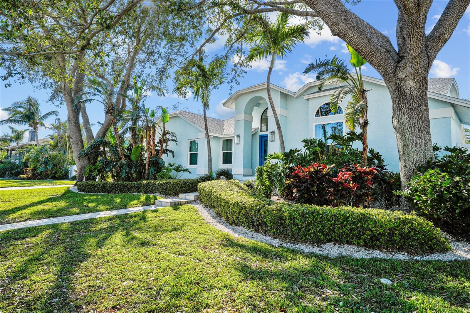 Welcome to this exquisite Tropical Paradise in Tierra Verde. Situated on over a quarter of an acre, this four-bedroom residence features a freeform pool with spa and a private sport court. Host gatherings for friends and neighbors with activities such as basketball games, morning yoga sessions, or convert the space into a private pickleball court. Upon entering, you will be greeted by a grand foyer leading to formal dining or living areas, all seamlessly connected to the covered lanai. To the left, a spacious gathering room encompasses an updated open kitchen with a breakfast bar, providing ample space for movie nights or game nights. This room is enhanced by a fireplace and several cozy reading nooks, flooded with natural light from skylights in the vaulted ceilings and sliding doors that open to the pool and lanai. The split bedroom layout ensures privacy for the Primary Suite. This luxurious retreat includes a large bedroom with sliding doors to the pool and patio, an ensuite bath with a double vanity, walk-in shower, and water closet, as well as a walk-through closet with custom built-ins for efficient storage. The second and third bedrooms, located on the opposite side of the home, share a hall bath with a double vanity and a tub with a shower. The fourth bedroom, featuring a private exterior entrance, serves as an ideal home office, fitness room, or guest space. Natural light permeates the entire home through expansive windows, sliding doors, and skylights, further accentuated by vaulted ceilings. The wide driveway and attached two-car garage provide ample parking and storage solutions, with space for bikes and beach toys. Additionally, the garage is equipped with an EV charger and an adjacent laundry room. Residents can store or rent a boat at Tierra Verde Marina, enjoy dining at Island Grill, or watch the sunset with cocktails at the rooftop bar, all within walking distance. Tierra Verde, an island community at the southern end of Pinellas County, offers easy access to the natural shoreline and pristine beaches of Ft. DeSoto Park, bicycle trails, and the interstate. It is conveniently located a few minutes from Downtown St. Petersburg, thirty minutes from Tampa International Airport, and a short drive south across the Skyway Bridge to Bradenton, Sarasota, and beyond