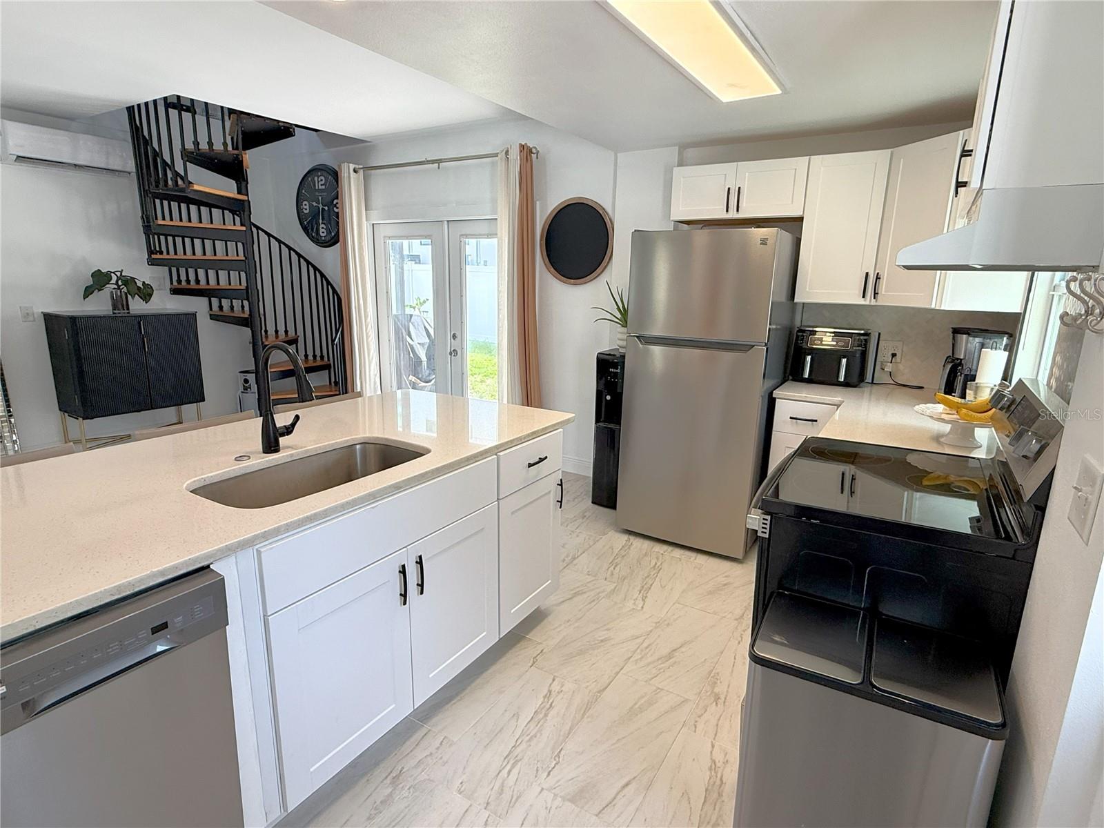 Modern meets cozy in this 2-bed, 1.5-bath move-in ready home located in the historic and highly desirable Port Tampa area just minutes from Picnic Island Park, MacDill AFB, and Gandy Bridge! Featuring quartz countertops, stainless steel brand-name appliances, energy-efficient mini-splits for cooling, tile floors downstairs and laminate flooring upstairs, spiral staircase, fenced yard, fire pit, and galvanized steel shed—plus NO HOA. Bring your boat, trailer or RV and enjoy the Florida lifestyle.
Upstairs offers two bedrooms—including a covered rear porch—and a full bath. Both bedrooms provide closet space and each bathroom contains built-in shelves for extra storage space. Walk outside through the French doors to your fenced in oasis complete with a fire pit.
Enjoy the close proximity to Picnic Island, offering a boat ramp, dog beach, frisbee golf course, reservable pavilions for events, sand volleyball court, and much more. Also nearby are top rated schools, a marina district and a lively mix of shops, dining and fitness centers.
A fantastic starter home or rental-ready investment near the water and the base!
Other features of note include:
• Charming brick road leading to home;
• New mini splits installed in 2021;
• 2020 roof;
• House painted 2025;
• Side yard with double door gate allows safe storage of trailer, boat or RV (no HOA);
• Includes washer and dryer & dishwasher and disposal;
• Additional stairway in back that leads to the rear covered porch;
Disclaimer: Listing agent is the owner/seller. Owner/seller is a FL licensed Sales Associate and REALTOR®.