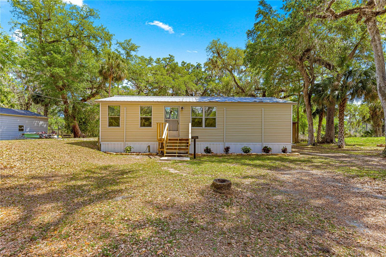 Seller will consider reasonable offers. Spacious & Renovated 3-Bedroom Double Wide Mobile Home on Oversized Lot – Prime Location! Discover this beautifully remodeled 3-bedroom, 2-bathroom mobile home on a generous 0.33-acre lot, featuring brand-new flooring, fresh paint, and a durable metal roof. Stay comfortable with four new energy-efficient Gree mini-split A/C units (installed in 2025) with humidity control, a super energy-saving mode, and a 10-year warranty. Additional upgrades include a new hot water heater (2024), upgraded outlets and receptacles (February 2025). The home also offers a covered rear porch, a spacious storage area, a modern floor laminate kitchen with a dishwasher, a brand-new refrigerator, electric water heater and range hood. The property comes with an outside lighting (SECO light) and termite bait stations for added protection. We have a 4-point inspection conducted on the property in June 2023. The home has been unoccupied since October 2024, ensuring it is in excellent condition. Located in a rapidly growing area with new homes being built all around, this property is a fantastic opportunity for homeowners and investors alike, and best of all, you own the land—no lot fees, no HOA! Perfectly situated between Ocala and Orlando, this home offers the ideal balance of city convenience and peaceful living, with Lake Panasoffkee just one mile away, providing access to multiple public boat ramps, including Panavista Lodge (with a fish camp), Tracy’s Point Lodge (featuring eight stunning waterfront cabins), and Marsh Bend Outlet Park (offering hiking trails, boat ramps, fishing spots, and picnic areas). Don’t miss out on this incredible opportunity—schedule your showing today!