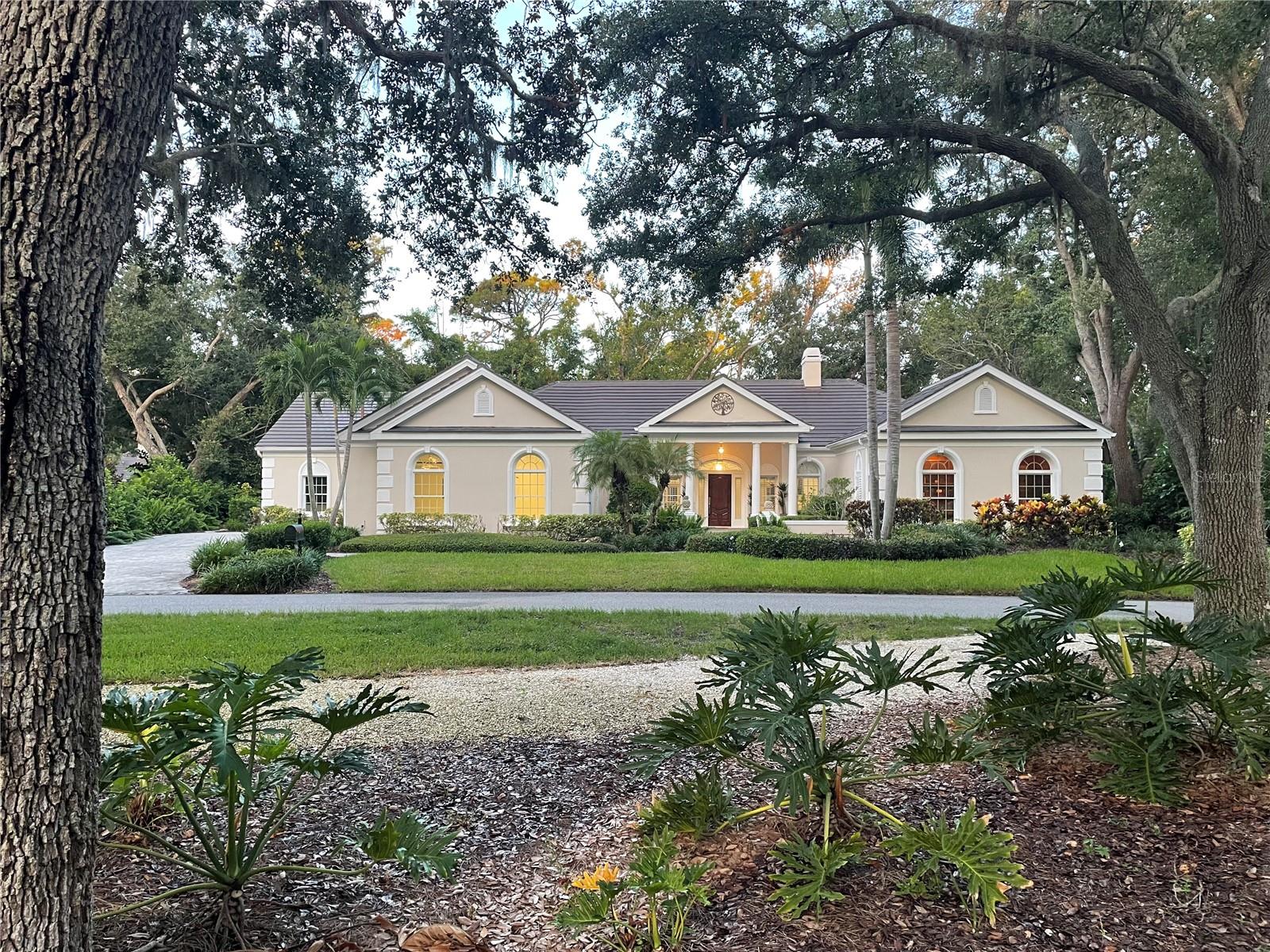This is your rare chance to claim a spectacular estate in Sarasota’s premier golf and country club community THE OAKS. This elegant home seamlessly blends timeless architecture with resort-style living. Beyond the private gates, step into over 4,000 square feet of refined interiors featuring dramatic ceilings, architectural columns, and panoramic views. The expansive layout includes 4 bedrooms, 5 bathrooms, formal and casual living spaces, and an executive Office/Den/Bourbon Tasting Room.
The gourmet kitchen is perfectly equipped for culinary entertainment, with custom cabinetry, premium appliances, and a spacious island that flows into the family room. A luxurious owner’s suite provides a private sanctuary with jetted bath, 3 walk-in closets, and direct access to the pool terrace.
Outdoors, your personal retreat awaits: a heated pool and spa, covered dining and lounge areas, separate firepit area, and tropical landscaping.
Membership to The Oaks Country Club is mandatory. You can decide on a Social Membership or a Full Golf Equity Membership. Details attached. Club amenities include: 36 holes of golf, tennis, pickleball, croquet, 3 dining options, fitness, community pool/spa.
Situated minutes from world-class beaches, fine dining, and downtown Sarasota’s cultural attractions. Make this your new home in Paradise!
Crypto currency offers considered. Call for more information.
