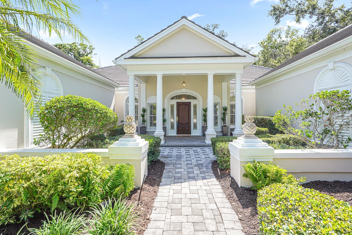Auction Property. Selling This Weekend Only (July 18th – 19th) for Highest/Best! Viewings from 9-5 on Friday, and 8-12 on Saturday. This is your rare chance to claim a spectacular estate in Sarasota’s premier golf and country club community at a great price. Auctioned by the homeowner, this elegant home seamlessly blends timeless architecture with resort-style living. No prequalification necessary to bid, no cash needed, traditional real estate closings
Beyond the private gates, step into over 4,000 square feet of refined interiors featuring dramatic ceilings, architectural columns, and panoramic views. The expansive layout includes 4 bedrooms, 5 bathrooms, formal and casual living spaces, and an executive office.
The gourmet kitchen is perfectly equipped for culinary entertainment, with custom cabinetry, premium appliances, and a spacious island that flows into the family room. A luxurious owner’s suite provides a private sanctuary with jetted bath, 3 walk-in closets, and direct access to the pool terrace.
Outdoors, your personal retreat awaits: a heated pool and spa, covered dining and lounge areas, separate firepit area, and tropical landscaping.
Situated minutes from world-class beaches, fine dining, and downtown Sarasota’s cultural attractions, this exceptional residence will be sold to the highest bidder, don’t miss this unique buying opportunity.