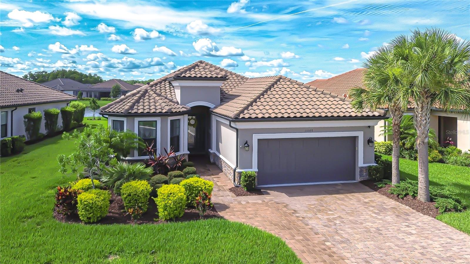Welcome home to Esplanade at Starkey Ranch—A beautiful gated community where every day feels like a getaway. Better than new and beautifully upgraded, this stunning home is located in the highly sought-after Esplanade at Starkey Ranch, a gated enclave within the award-winning Starkey Ranch master-planned community. Residents of Esplanade enjoy exclusive access to resort-style amenities designed for vibrant, inspired living. This popular Lazio floor plan by Taylor Morrison is celebrated for its open-concept design, offering 3 well-appointed bedrooms and a versatile den—perfect for today’s flexible lifestyle. At the heart of the home is a chef-inspired kitchen, showcasing 42” white cabinetry, a 5-burner gas cooktop, built-in convection oven and microwave, quartz countertops, and a spacious island perfect for gathering. The kitchen flows seamlessly into the open dining and living areas, highlighted by a wall of glass sliders that extend your living space to the outdoors. The primary suite is a serene retreat with peaceful water views, an expansive walk-in closet, and a spa-like bath featuring dual vanities and an oversized, luxury shower. One secondary bedroom functions as a private en-suite with its own full bath and walk-in closet, while the third guest room—tucked on the opposite side of the home—features a charming bay window and nearby full bath, creating a comfortable guest suite. Step out to the extended lanai—complete with fireplace and tranquil pond views—ideal for relaxing or entertaining year-round. Additional upgrades include a custom tandem garage with extra storage, landscape lighting, rain gutters, new designer lighting, and more. Living in Esplanade means more than just a beautiful home—it’s a lifestyle. Lawn maintenance is included in the HOA, allowing you to spend more time enjoying the exclusive resort-inspired amenities like tennis, pickleball, fitness center, clubhouse, pool, and golf cart-friendly trails. Copy and paste this link to tour the home virtually: my.matterport.com/show/?m=eymivoBHhtM&mls=1