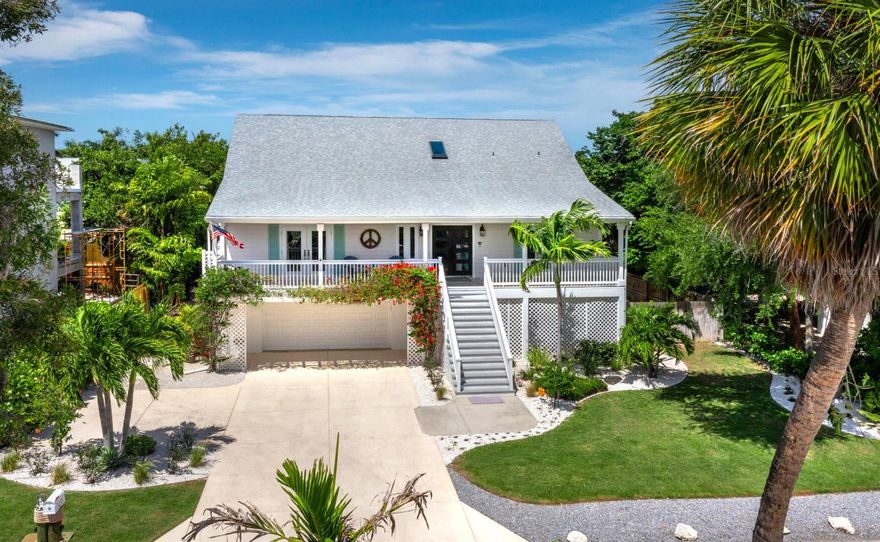 Welcome to Bay Island, ideally positioned on the north end of Siesta Key, where island living meets exceptional convenience. Just moments from Siesta Beach, Siesta Key Village, and downtown Sarasota’s waterfront dining and cultural offerings—with easy access on and off the island—this elevated Key West-style residence is set across a rare double lot, an uncommon offering on Siesta Key. Fully renovated in late 2019, the home features new siding, roof, electrical, plumbing, irrigation, hurricane-rated windows and French doors, and two HVAC systems. It has since been further enhanced with premium retractable invisible screens on all French doors, kitchen and bath refinements, and a whole-house water filtration system, along with additional upgrades that reflect its continued care and quality. The open-concept floor plan is filled with natural light, highlighted by vaulted ceilings, LVP flooring, and a natural gas fireplace. Multiple covered terraces extend the living space outdoors, reinforcing the home’s relaxed coastal design. The kitchen is designed for both everyday living and entertaining, centered around a large quartzite island with extensive drawer storage and pull-out shelving. A full Thermador appliance package includes a gas range, refrigerator and freezer columns, and dishwasher. Soft-close cabinetry and thoughtful storage solutions provide both function and efficiency. French doors open to an oversized covered deck overlooking mature tropical landscaping. The well-sized owner’s suite is located on the main living level and includes a walk-in closet and a private en-suite bathroom featuring a double vanity and large walk-in shower. A den on this level offers flexibility and can easily serve as a fourth bedroom or home office. Upstairs, two generously sized guest bedrooms share a newly appointed bathroom and enjoy access to a third-level terrace ideal for sunset views.  Outdoor living sets this property apart. The double lot creates an expansive backyard with a recently resurfaced pool, travertine decking, and multiple covered terraces—an uncommon offering on Siesta Key. The additional lot provides flexibility for future enhancements while preserving privacy and open space.