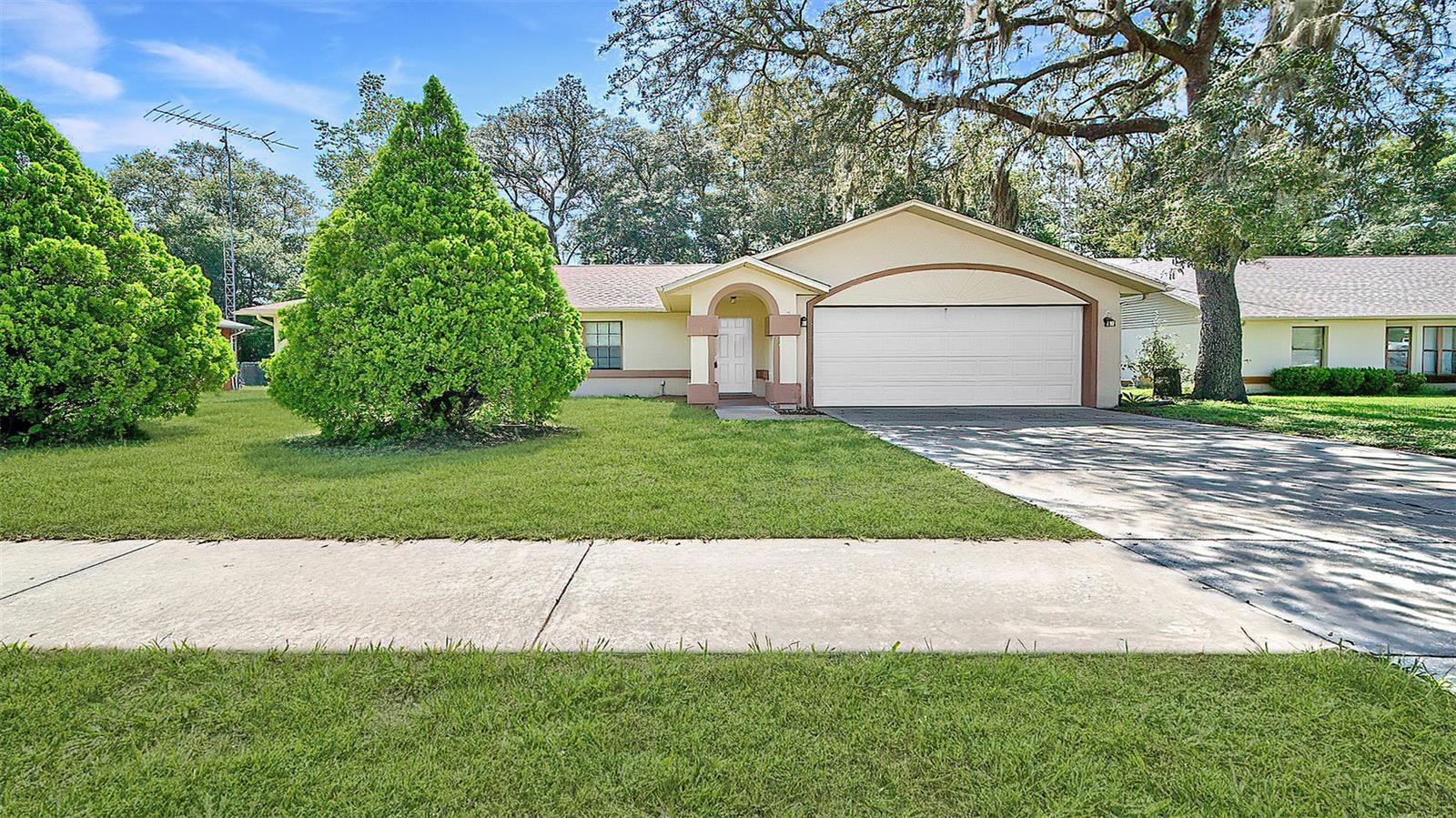 Move-in ready 3/2 home in quiet, peaceful neighborhood. Open floor plan with vaulted ceilings. Spacious kitchen with dinette and bar area.
Backyard features mature trees and enclosed lanai patio. Split floor plan with three bedrooms. Primary suite includes walk-in closet, dual sinks, makeup vanity, and private shower area. Two guest bedrooms with large closets and ceiling fans. Guest bathroom with skylight. All appliances included, reliable AC, and two-car garage. Located in Citrus Springs, known for its welcoming community and convenient amenities. This well maintained home features An enclosed screen room which provides a relaxing retreat while observing birds. The home gives the impression of a serene country setting, yet it is conveniently located just minutes from shopping, restaurants, and the picturesque Rainbow River in Dunnellon. Schedule your showing today.