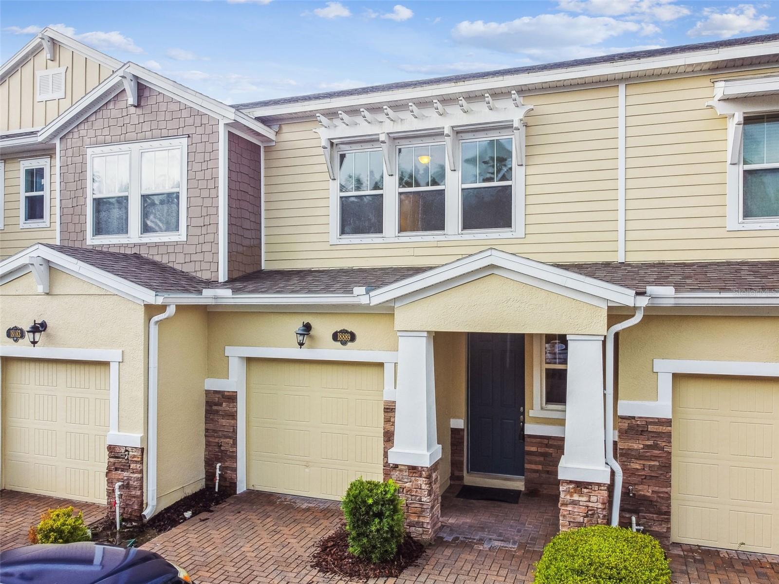 Newly listed in the prestigious Long Lake Ranch community of Lutz, FL! This stunning 3-bedroom, 2.5-bathroom townhome, built in 2017, offers 1,703 sq. ft. of modern elegance and comfort. Nestled in a vibrant, amenity-rich neighborhood, this townhome boasts an open-concept floor plan perfect for entertaining or cozy family nights. Step inside to discover a bright and airy interior with soaring volume ceilings that enhance the spacious feel. The kitchen is a chef’s delight, featuring granite countertops, stainless steel appliances, rich dark wood cabinetry, and a large center island with a breakfast bar that flows seamlessly into the living and dining areas. Large windows flood the space with natural light, creating a warm and inviting atmosphere. The expansive master suite is a true retreat, complete with a generous walk-in closet and a luxurious en-suite bathroom featuring dual sinks and a beautifully tiled shower. Two additional bedrooms provide ample space for family, guests, or hobbies. Enjoy your morning coffee or evening relaxation on the private screened lanai. Long Lake Ranch offers resort-style amenities, including a community pool, clubhouse, basketball and tennis courts, playground, dog park, and lake access—perfect for an active lifestyle. Conveniently located near top-rated schools (Oakstead Elementary, Charles S. Rushe Middle, and Sunlake High), dining, shopping, and major highways like the sun coast expressway, this home combines luxury with unmatched accessibility. This meticulously maintained and MOVE-IN READY townhome is ready for you to call home.
