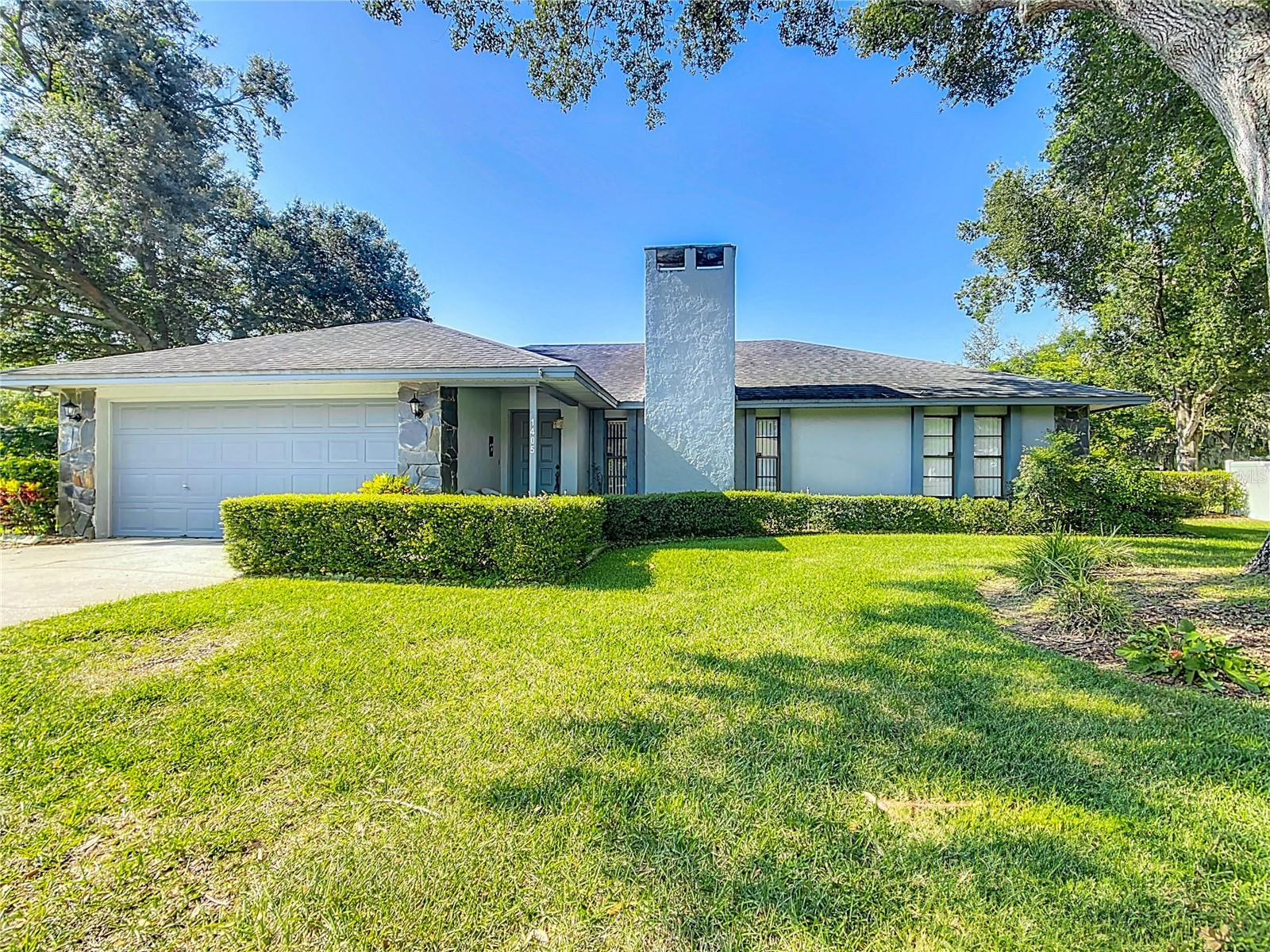 Welcome to 1405 Ridgegreen Loop N—your Florida retreat nestled beneath mature oaks in one of Lakeland’s most established and picturesque neighborhoods. This spacious and well-maintained 3-bedroom, 2-bath home blends timeless charm with modern upgrades and an open floor plan designed for comfort, connection, and everyday ease, with NO HOA to restrict your lifestyle.
Set on a quiet street that ends in a cul-de-sac, the home offers the tranquility of limited traffic and a warm, neighborly atmosphere. Step inside to a bright, flowing layout where the living, dining, and kitchen areas come together seamlessly—perfect for entertaining, family gatherings, or simply enjoying the airy sense of space. A cozy wood-burning fireplace anchors the main living area, while the kitchen features a large central island with generous seating, ideal for casual meals and lively conversation.
An additional family room adds flexibility for hobbies, a home office, or a relaxed lounge space, and opens directly to a screened porch—a peaceful spot to enjoy morning coffee, evening breezes, or quiet weekends overlooking the fully fenced backyard. Whether you have pets, little ones, or a green thumb, this outdoor space is ready to adapt to your needs.
In addition to the attached 2-car garage, the ADDITIONAL DETACHED GARAGE provides extra parking, workshop potential, or it could be easily converted to an in-law suite. Major systems are already taken care of for your peace of mind, including a new roof (2016), A/C system (2017), and water heater (2017). You’ll also enjoy the benefits of an irrigation system, underground utilities, and thoughtful storage throughout.
Located just minutes from shopping, dining, parks, major theme parks, and I-4, 1405 Ridgegreen Loop N offers a rare combination of location, freedom, and flexibility.
Don’t miss your chance to own this move-in-ready gem. Schedule your private showing today!
