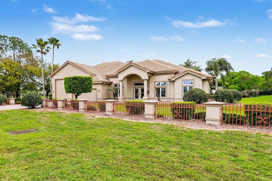 One or more photo(s) has been virtually staged. Located in the guard-gated Spruce Creek Fly-In community, this lovely home features a 1,740-square-foot garage, a tile roof, architectural details, and an open-concept, split-bedroom design that showcases attention to detail. With a view of the pool, golf course, and lake, the Great Room flows into the Kitchen, which includes a center island, 42-inch cabinets, tile backsplashes, solid surface counters, a breakfast bar, and a café area. The Primary Suite features French doors that lead to the lanai, along with an ensuite bathroom equipped with a dual vanity, a spacious walk-in shower, and a private toilet area. Each of the additional bedrooms includes a walk-in closet; one of these bedrooms also boasts an ensuite bathroom. Enhancing the home’s appeal are a formal Dining Room, a large Office with French doors, extensive crown molding, and designer ceilings. Additional amenities include a tankless water heater serving two baths, an electric patio shutter, and a 'safe' room closet in the primary suite. The multi-car garage has a 50’ x 20’ bay ideal for a Class-A motorcoach, two 50-amp outlets, a sewer access tap, and a utility sink. With a freshly painted exterior, an expansive paver driveway and attractive landscaping, this property has wonderful curb appeal. The 25-ft covered patio, screened lanai, and the heated pool and spa are perfect for Florida’s lifestyle and the community’s quality of life is unparalleled. Spruce Creek Fly-In offers a wide range of activities for residents. They benefit from numerous amenities, including private golf-car friendly streets, parks, a playground, and access to Spruce Creek Waterway for fishing or launching canoes and kayaks. Onsite management, 24-hour staffed security, a public restaurant, a hair salon, and various business services are within the community. The optional membership country club provides golf, pickleball, tennis, fitness facilities, a pool, and a private restaurant, and offers a flexible membership structure. In addition, the community features a private 4,000-foot paved runway equipped with a GPS approach, paved taxiways, and aviation services. The community’s convenient location allows easy access to local shopping, dining and entertainment. This represents a rare opportunity to purchase a beautiful home with an expansive garage in one of Central Florida’s most desirable communities. Visual Surveillance on premises.